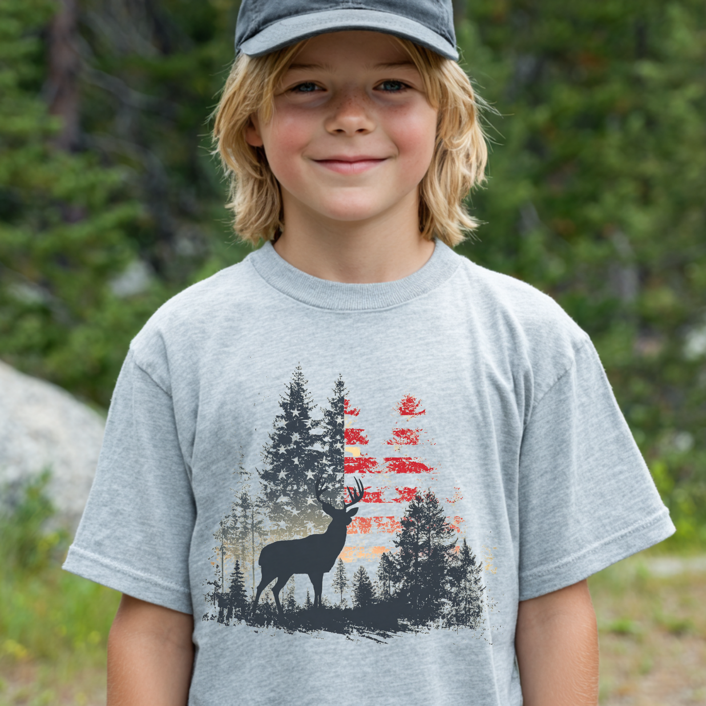 Child wearing a gray t-shirt with a nature-themed design outdoors