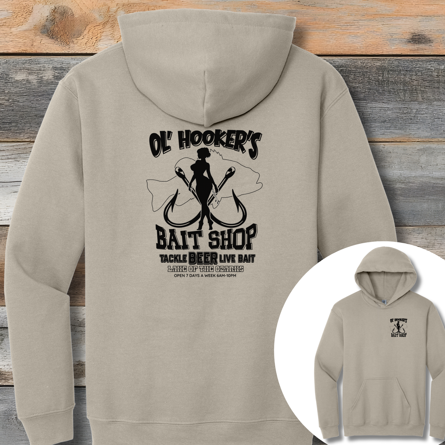 Beige hoodie with black graphic design on the back against a wooden background