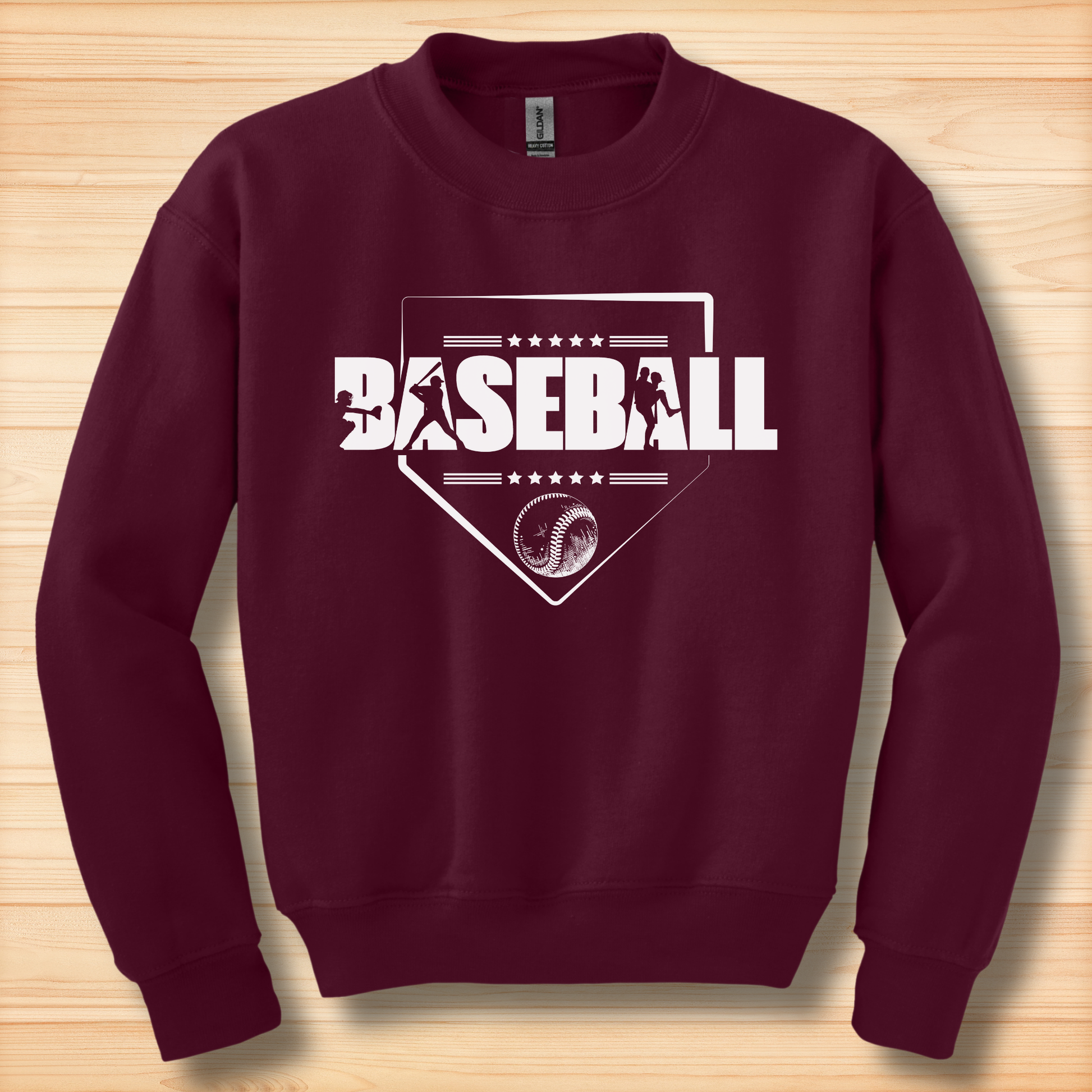 Maroon sweatshirt with baseball design on a wooden surface
