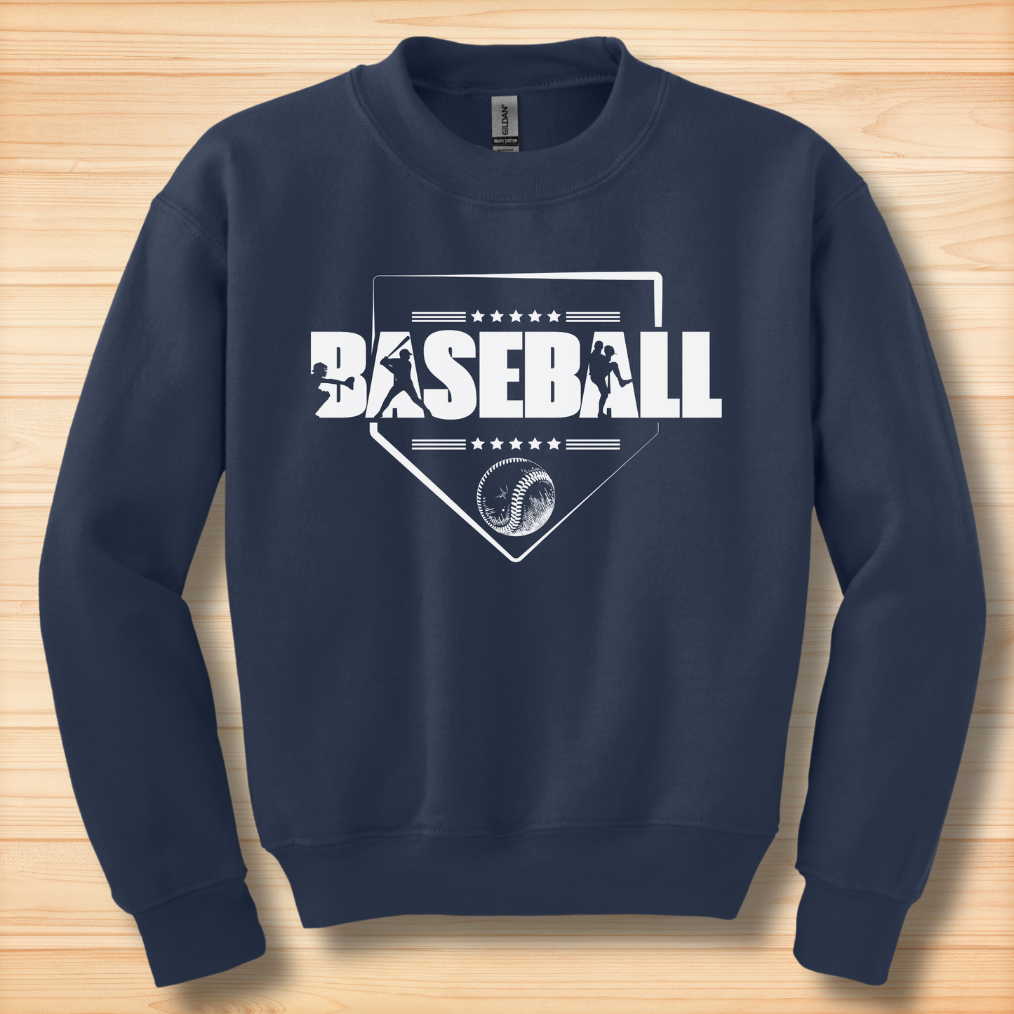 Navy blue sweatshirt with white baseball graphics and text on a wooden surface