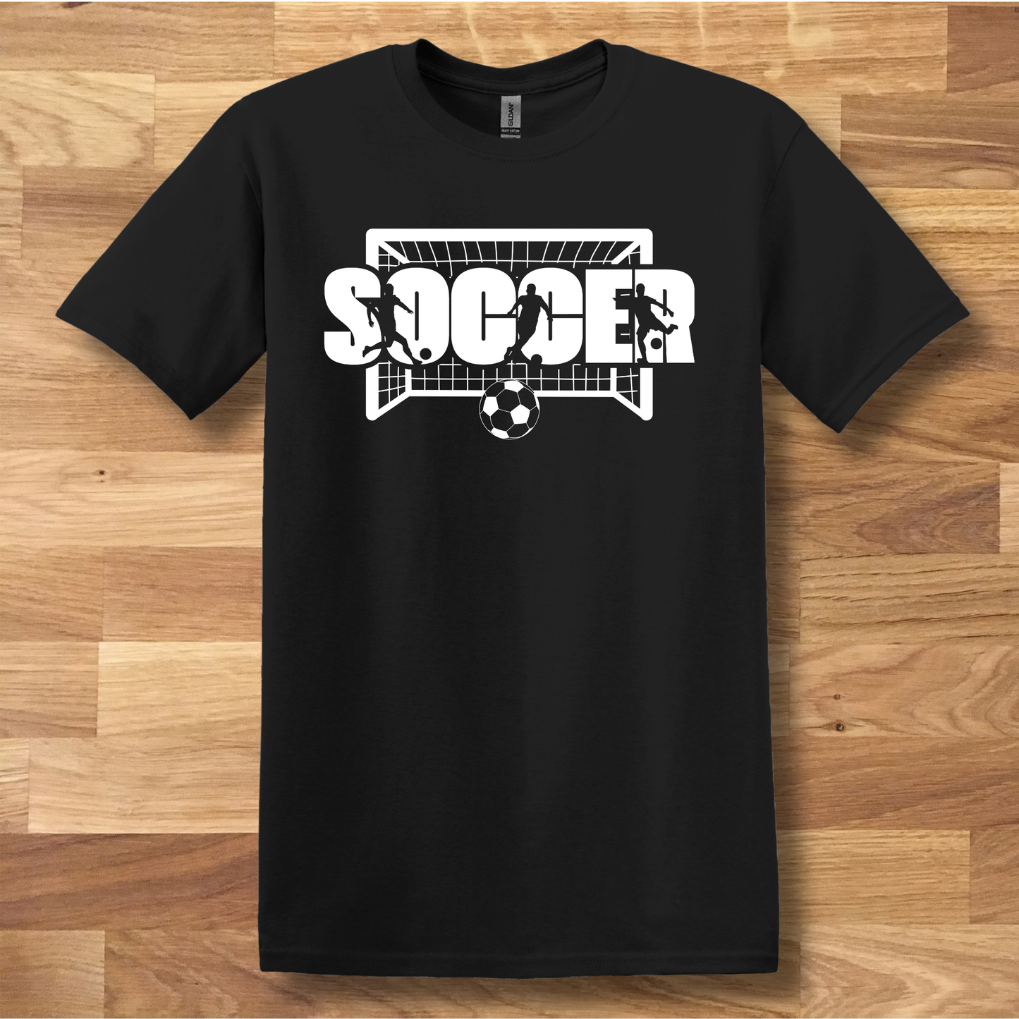 Black t-shirt with 'SOCCER' graphic on a wooden surface