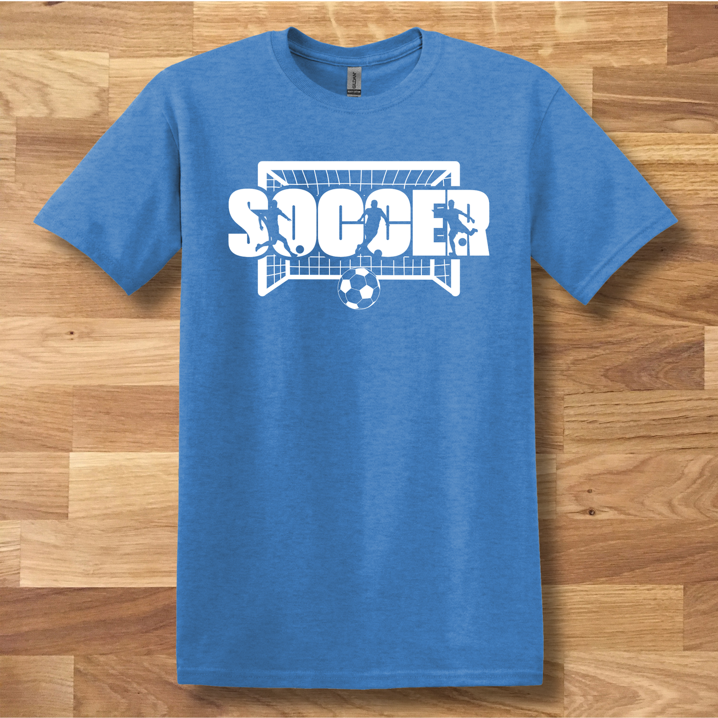 Blue t-shirt with 'SOCCER' graphic on a wooden surface