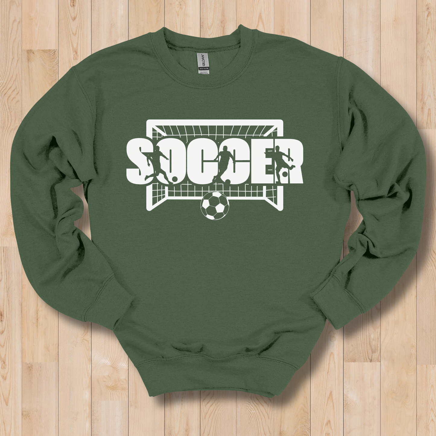 Green sweatshirt with soccer graphic on a wooden floor