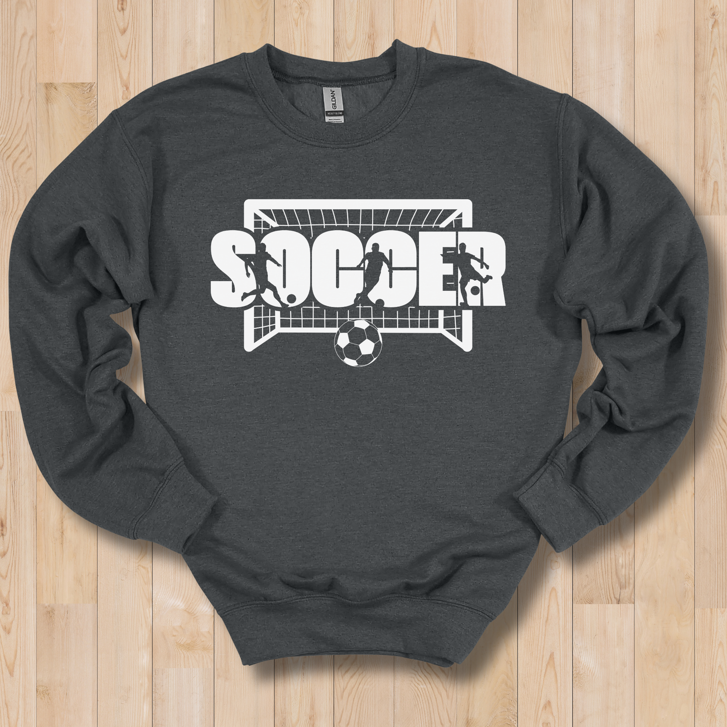 Dark gray sweatshirt with soccer graphic on a wooden surface