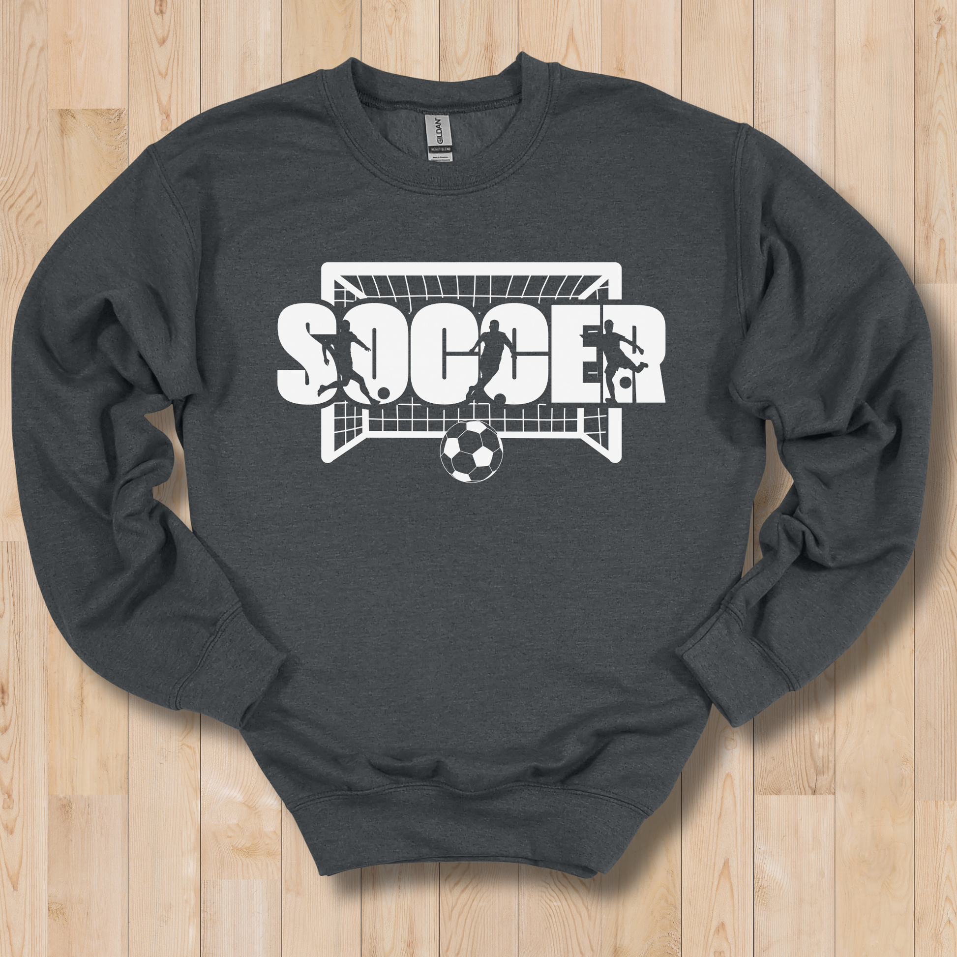 Dark gray sweatshirt with soccer graphic on a wooden surface