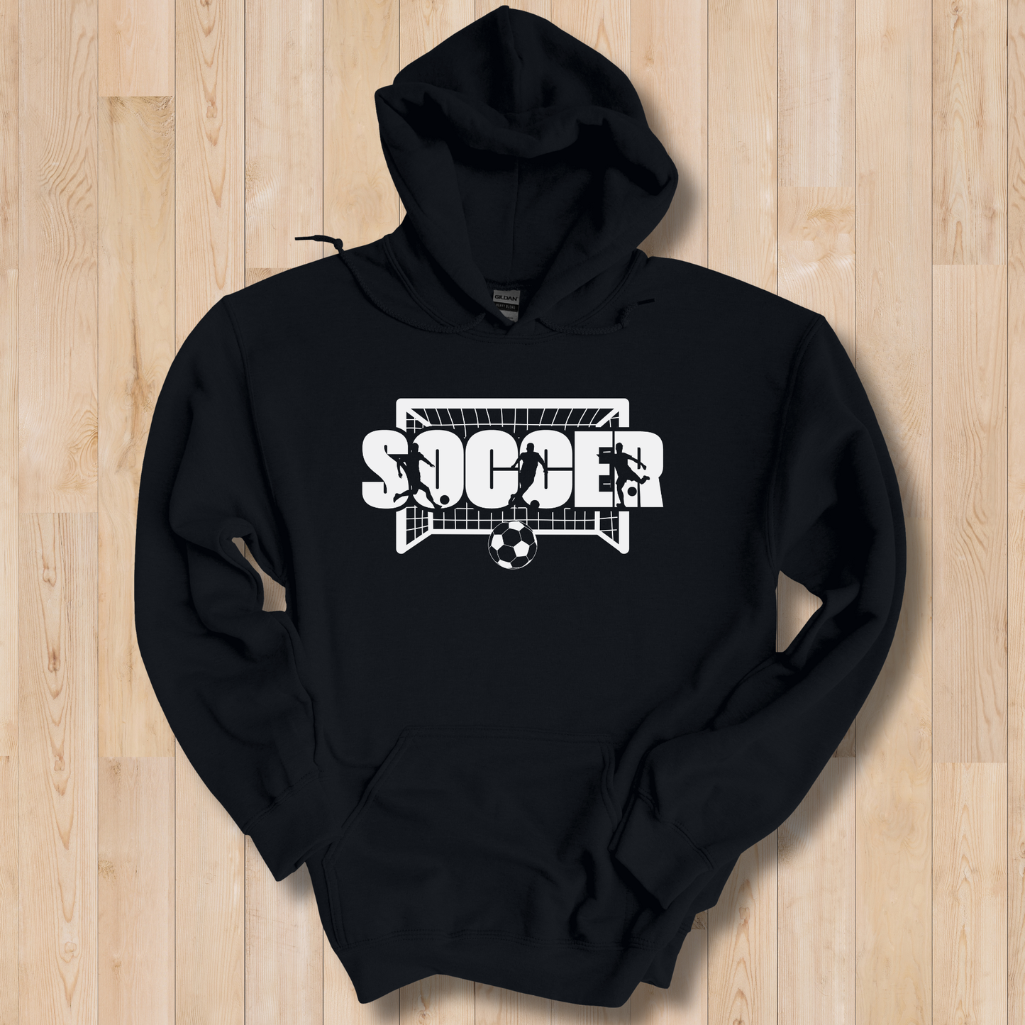 Black hoodie with 'Soccer' design on a wooden surface