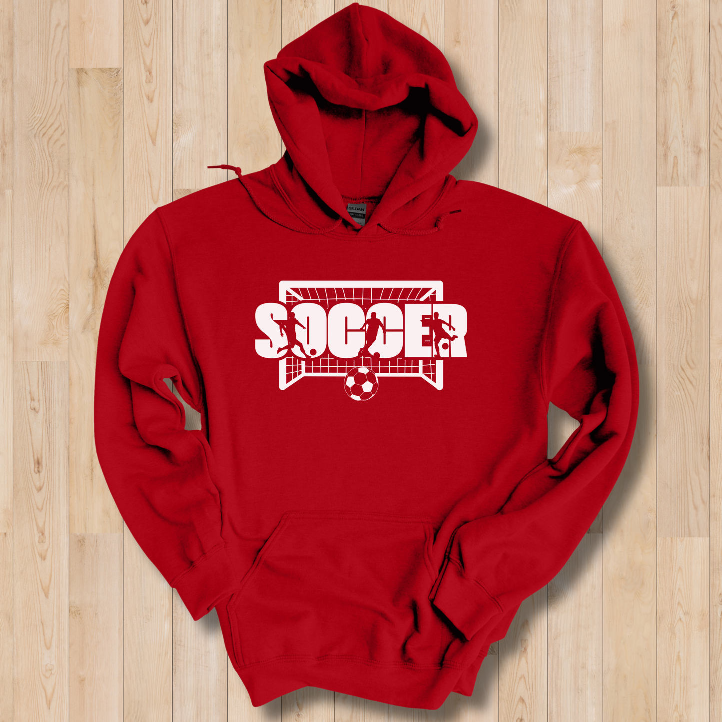 Red hoodie with 'Soccer' design on a wooden surface