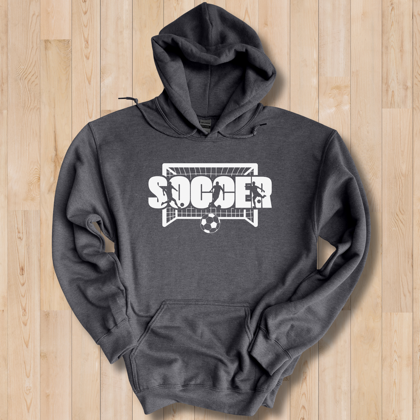 Dark gray hoodie with 'Soccer' graphic on a wooden surface