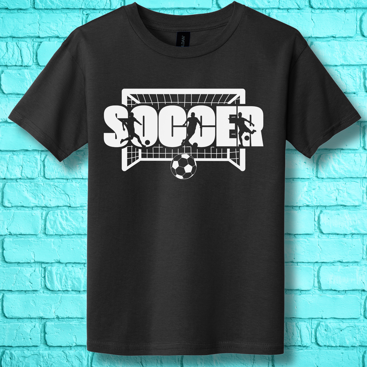 Black t-shirt with soccer graphic design on a blue brick wall background