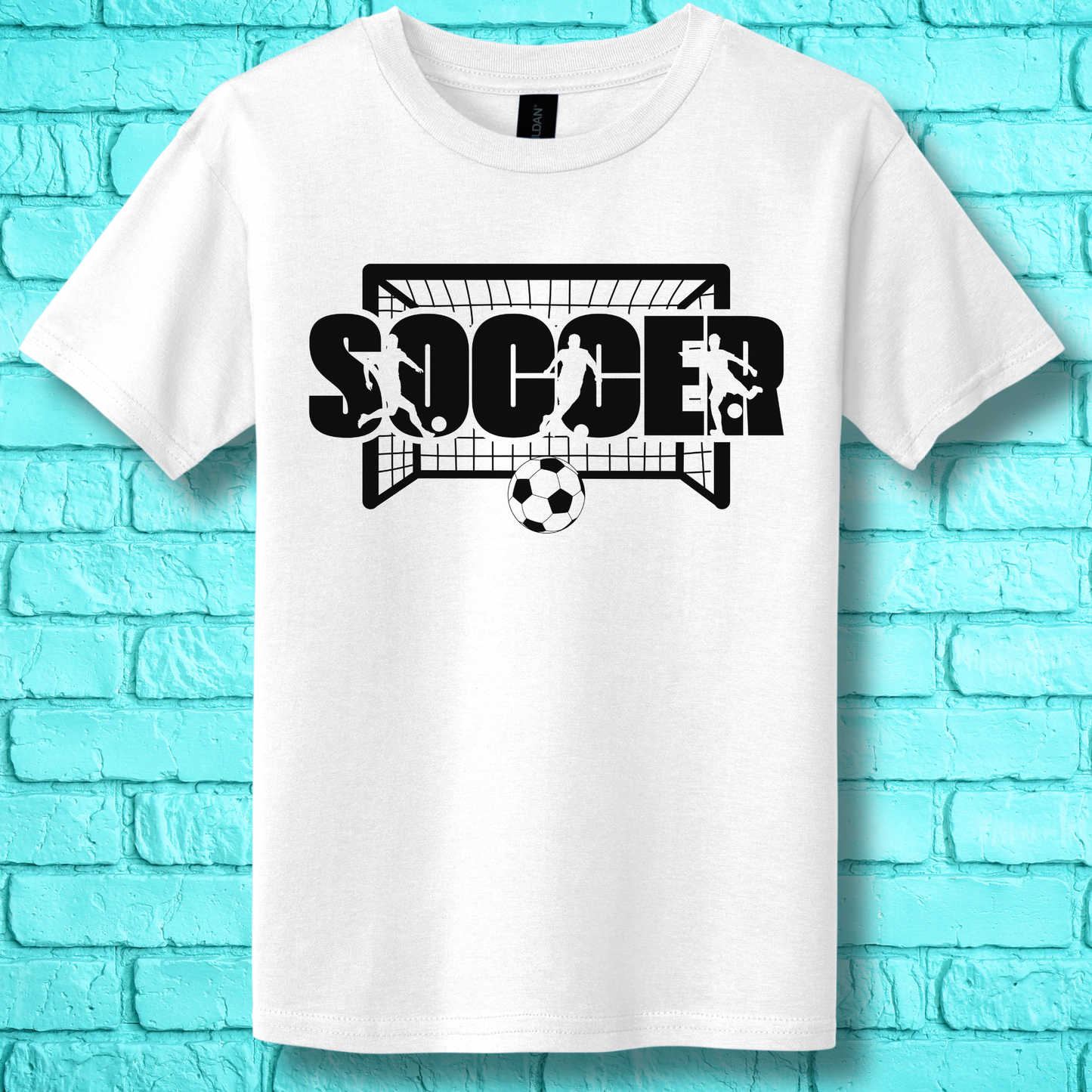 White t-shirt with 'SOCCER' graphic design on a blue brick wall background
