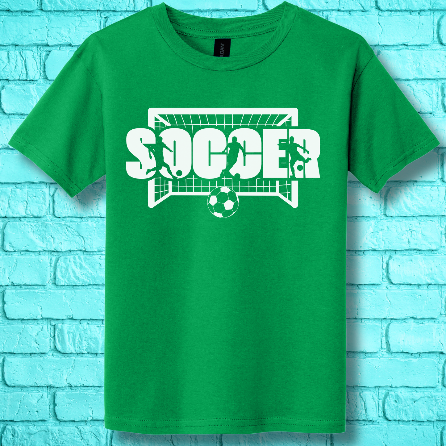 Green t-shirt with 'SOCCER' graphic on a light blue brick wall background