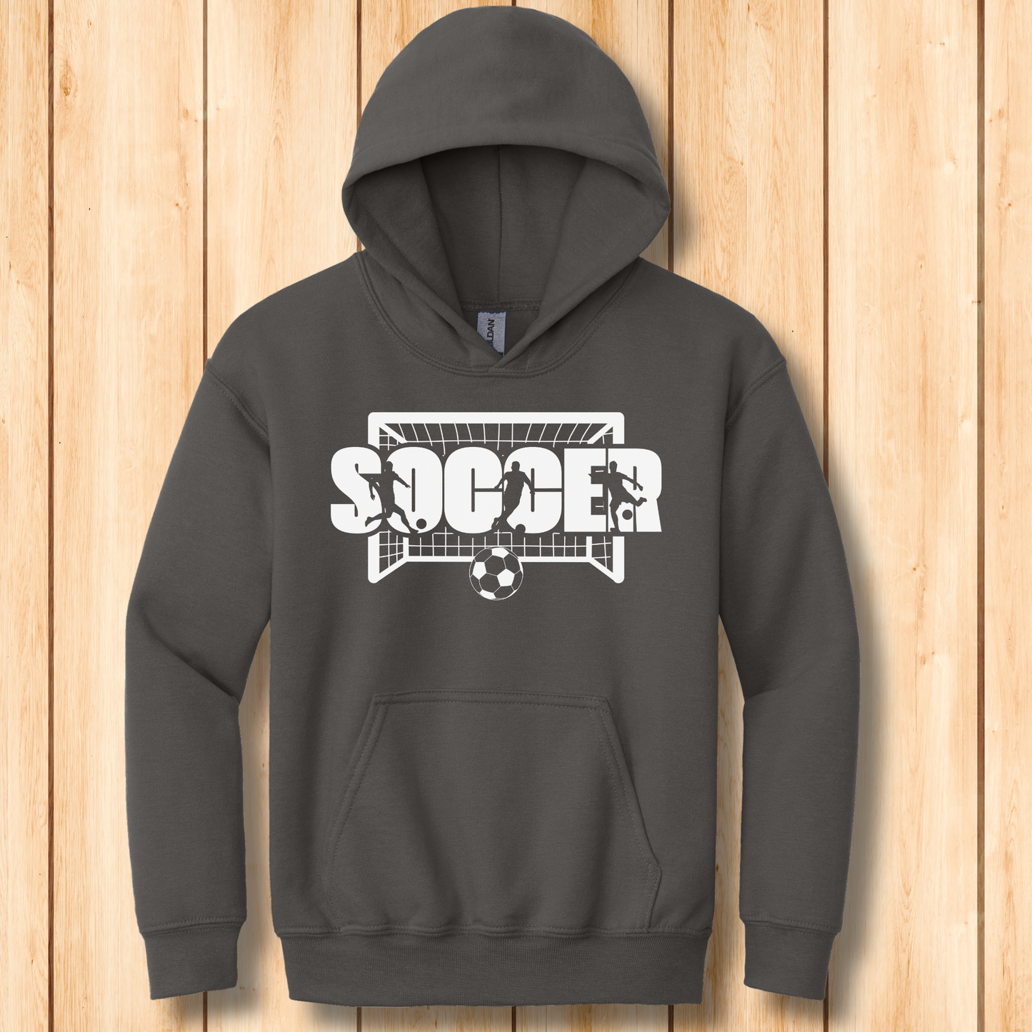 Dark gray hoodie with soccer graphic on a wooden surface