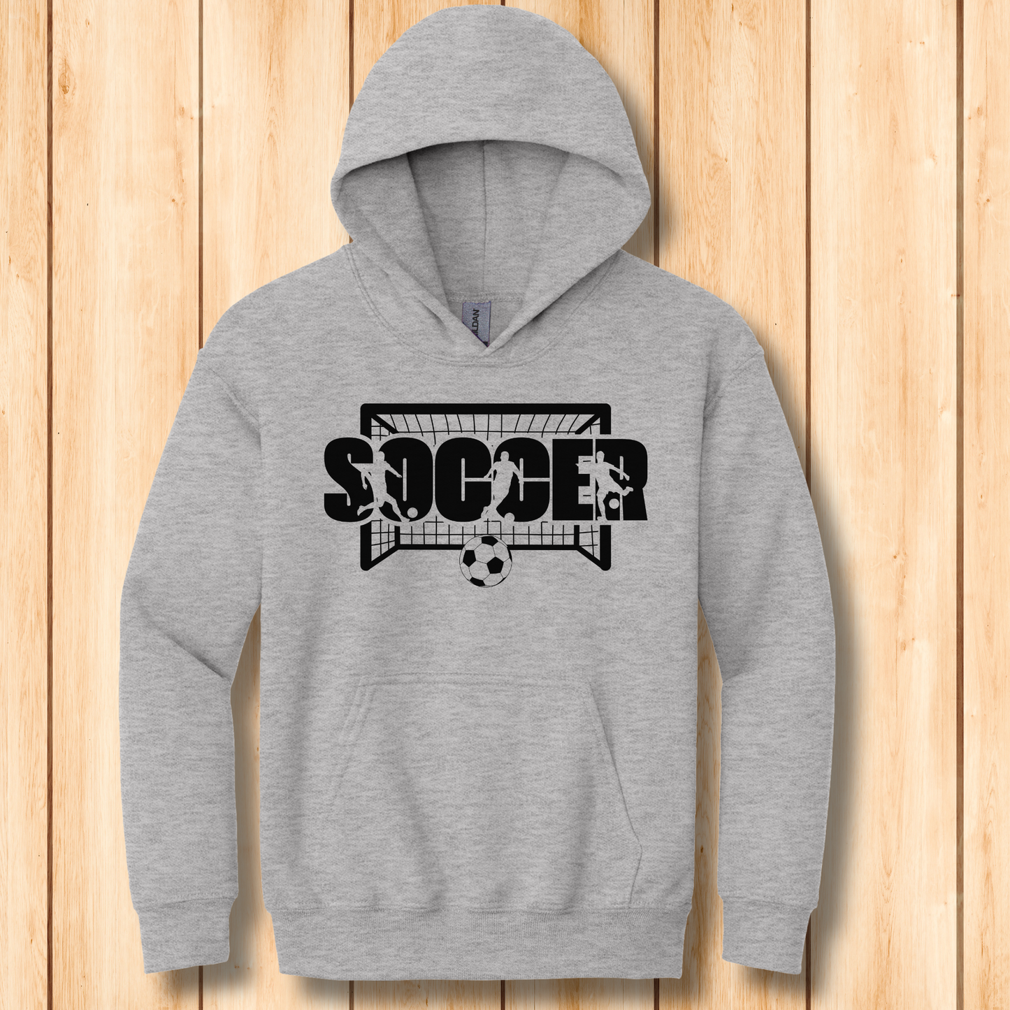 Gray hoodie with soccer design on a wooden background