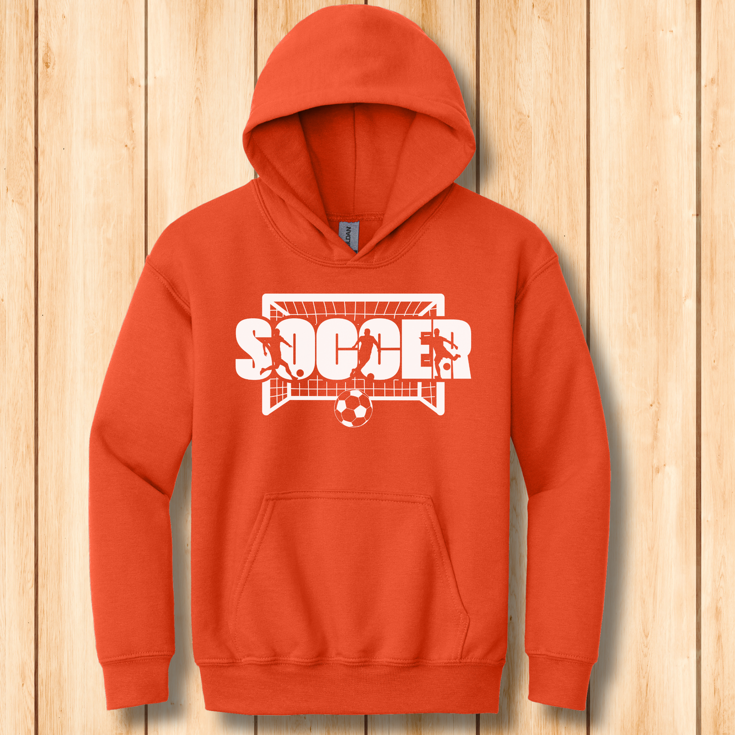 Orange hoodie with soccer graphic on a wooden background