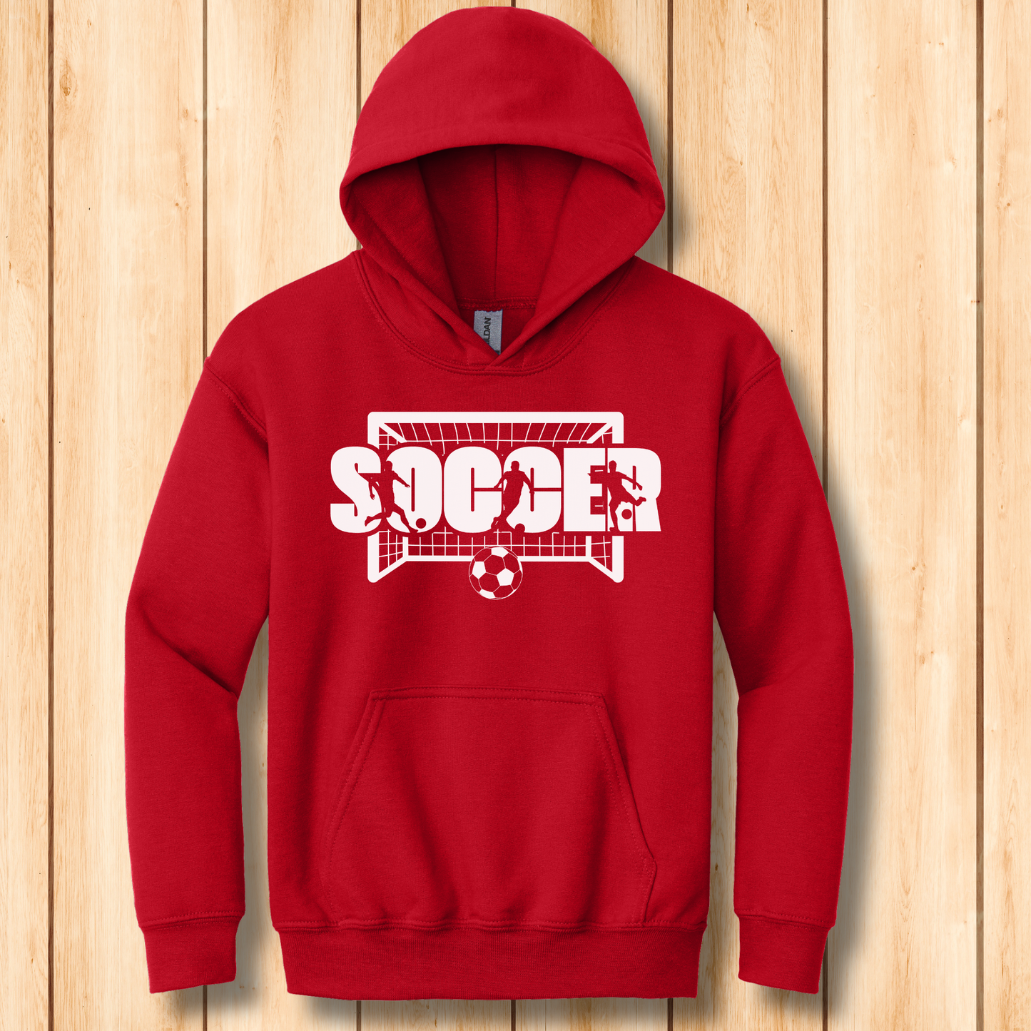 Red hoodie with 'Soccer' design on a wooden background