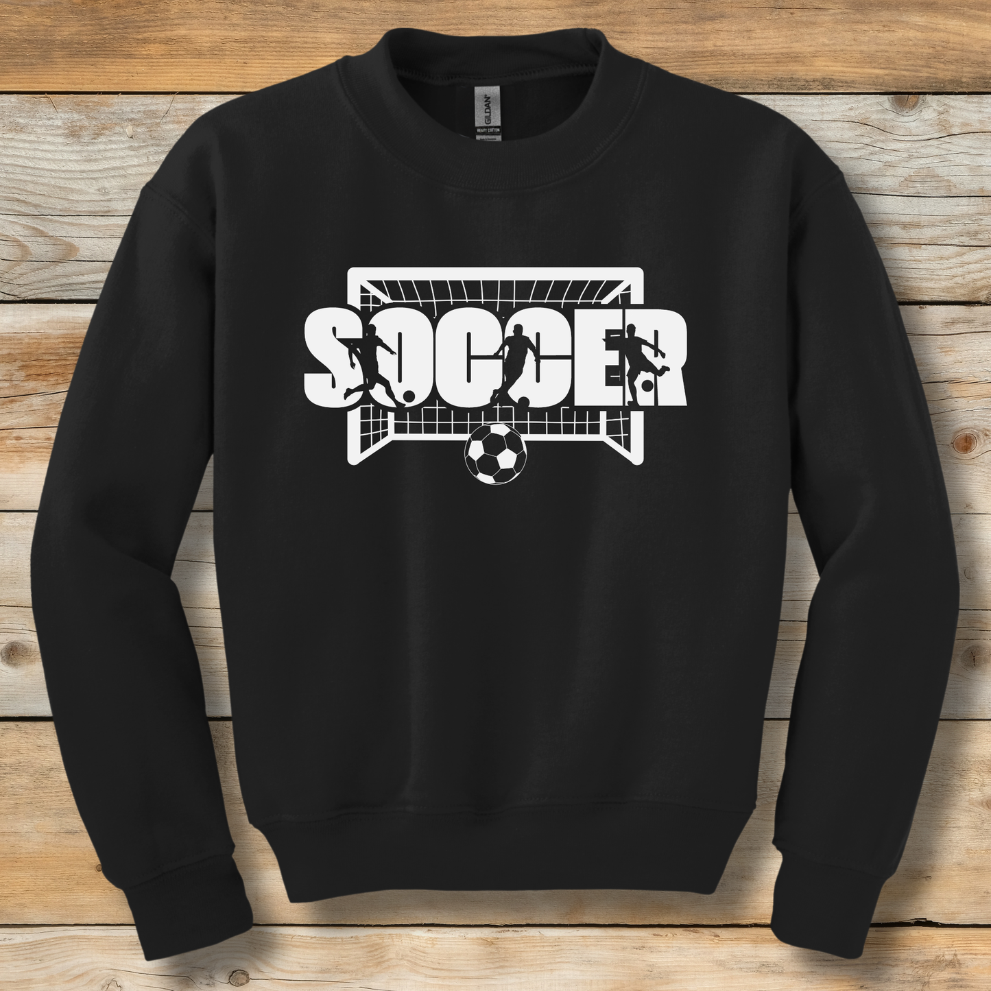 Black sweatshirt with soccer graphic on a wooden background