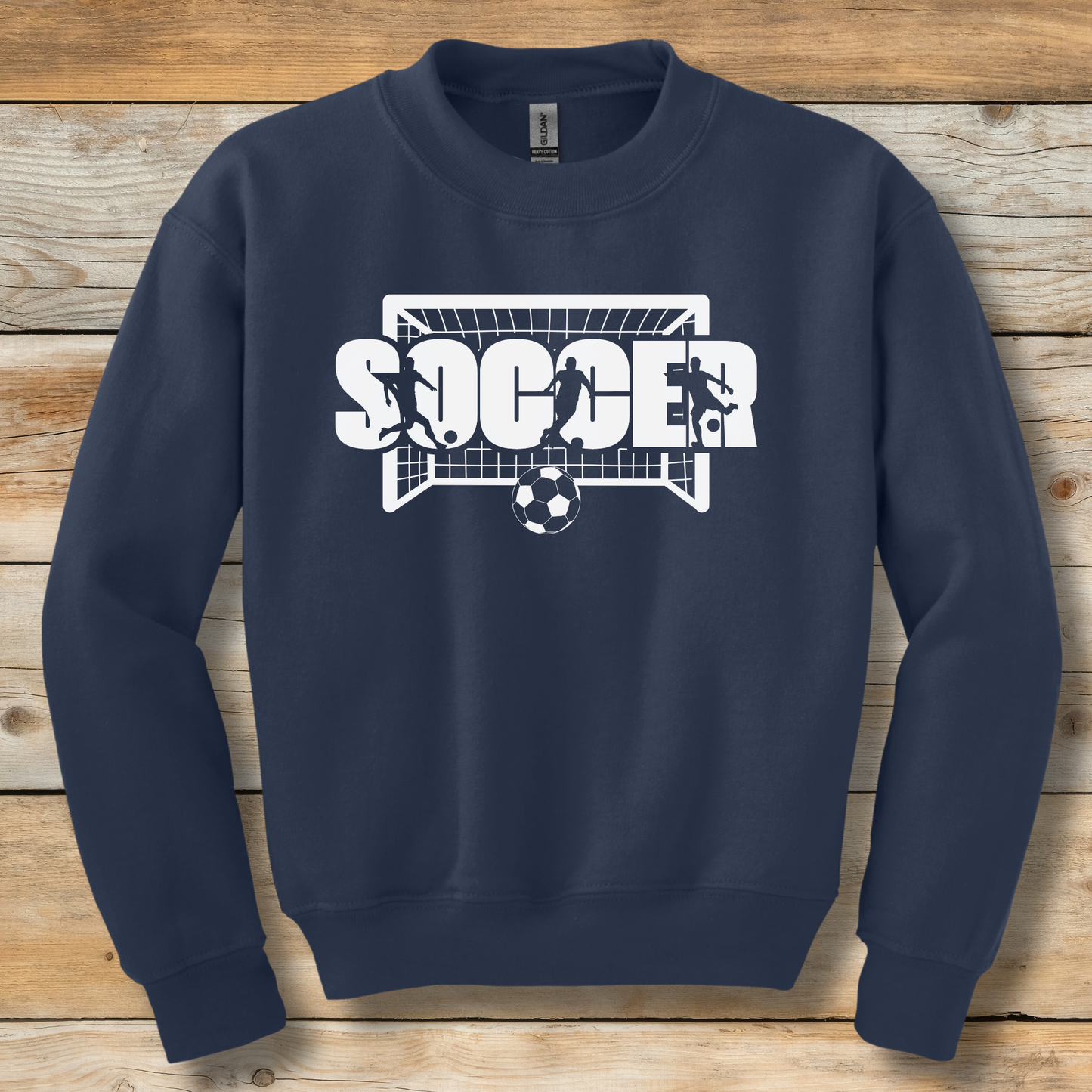 Navy blue sweatshirt with 'SOCCER' graphic on a wooden background