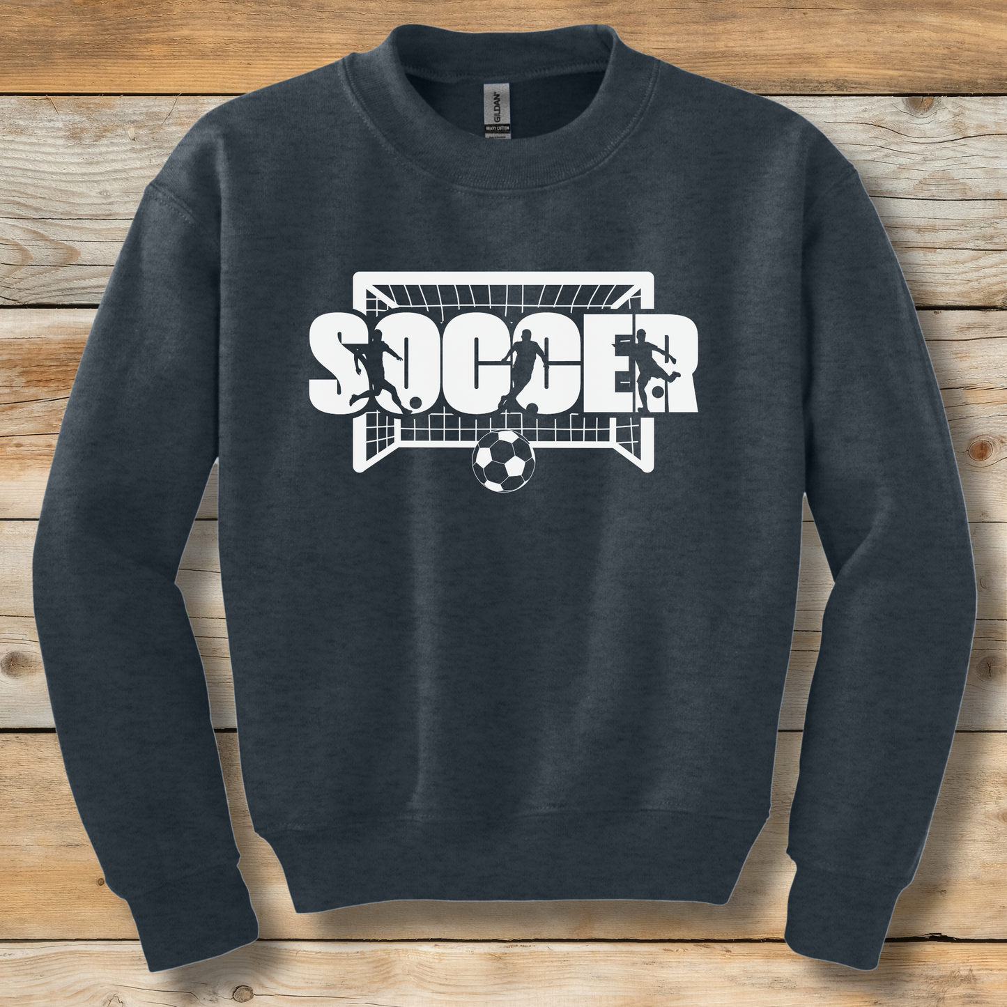 Dark gray sweatshirt with 'SOCCER' graphic on a wooden background