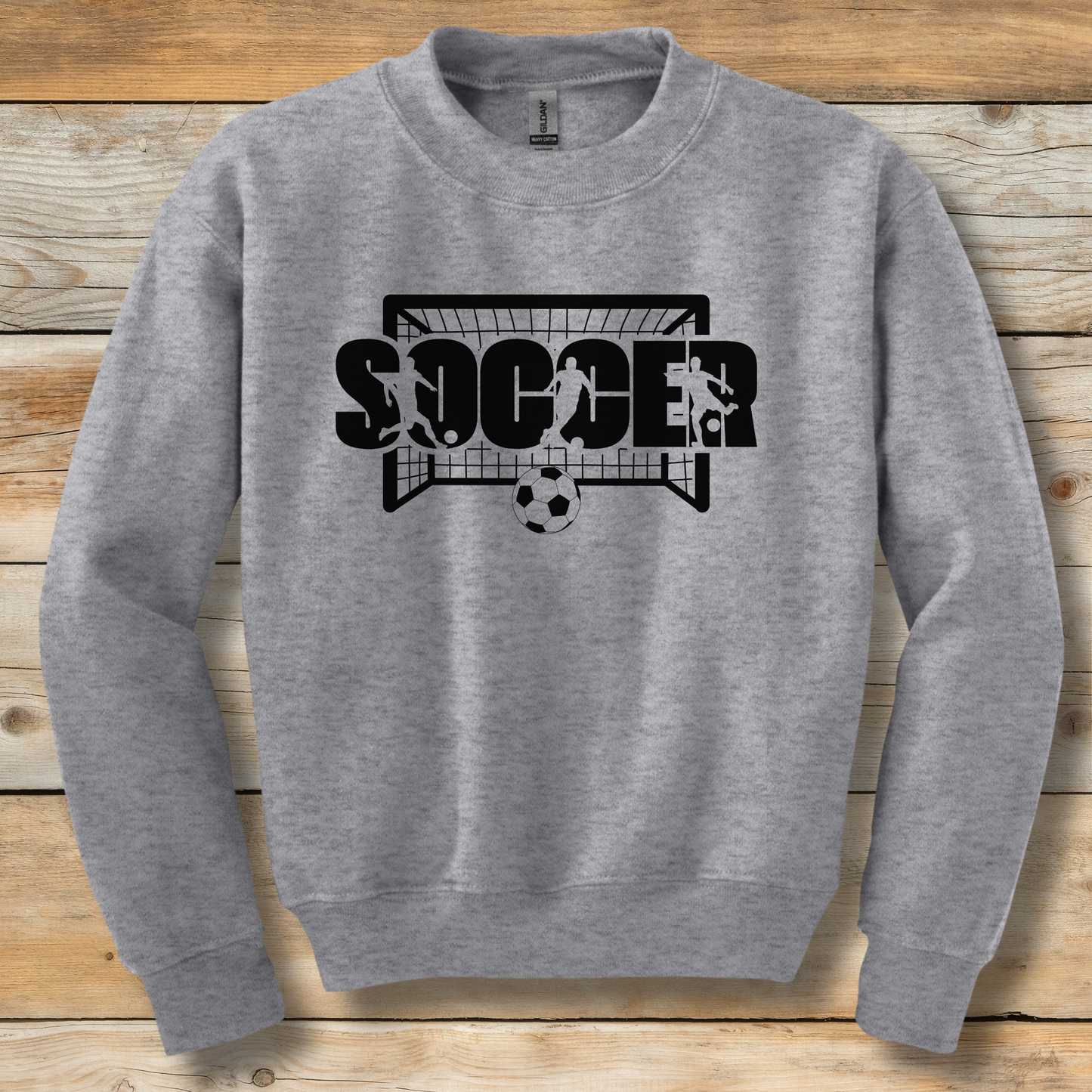 Gray sweatshirt with 'SOCCER' graphic on a wooden background