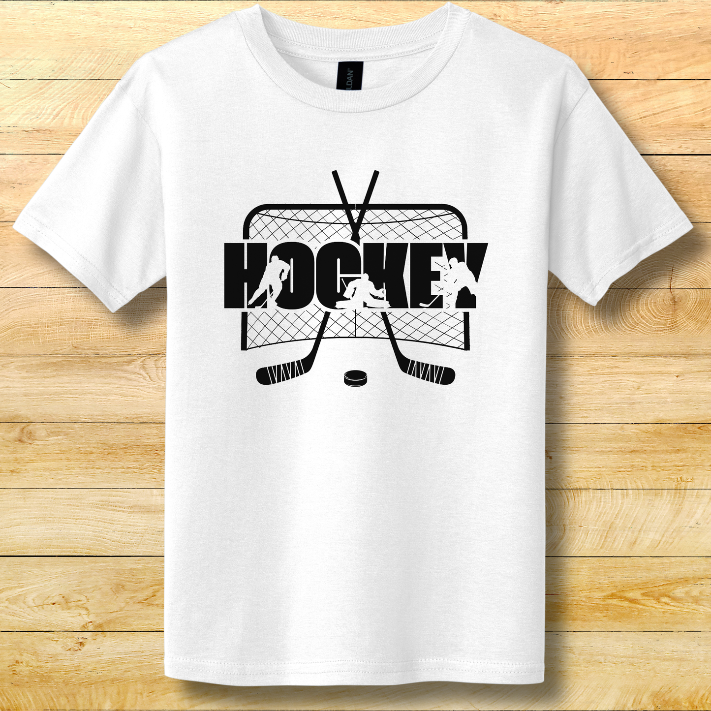White t-shirt with black hockey graphic on a wooden surface