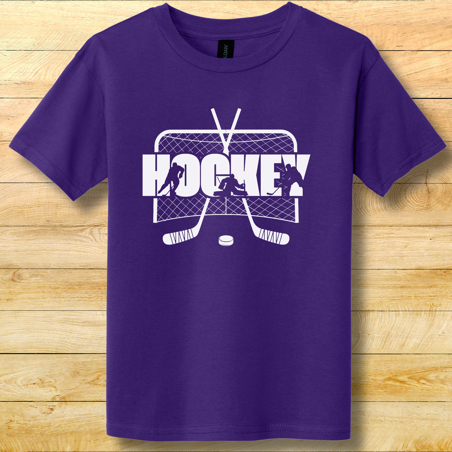 Purple t-shirt with white hockey graphic on a wooden surface