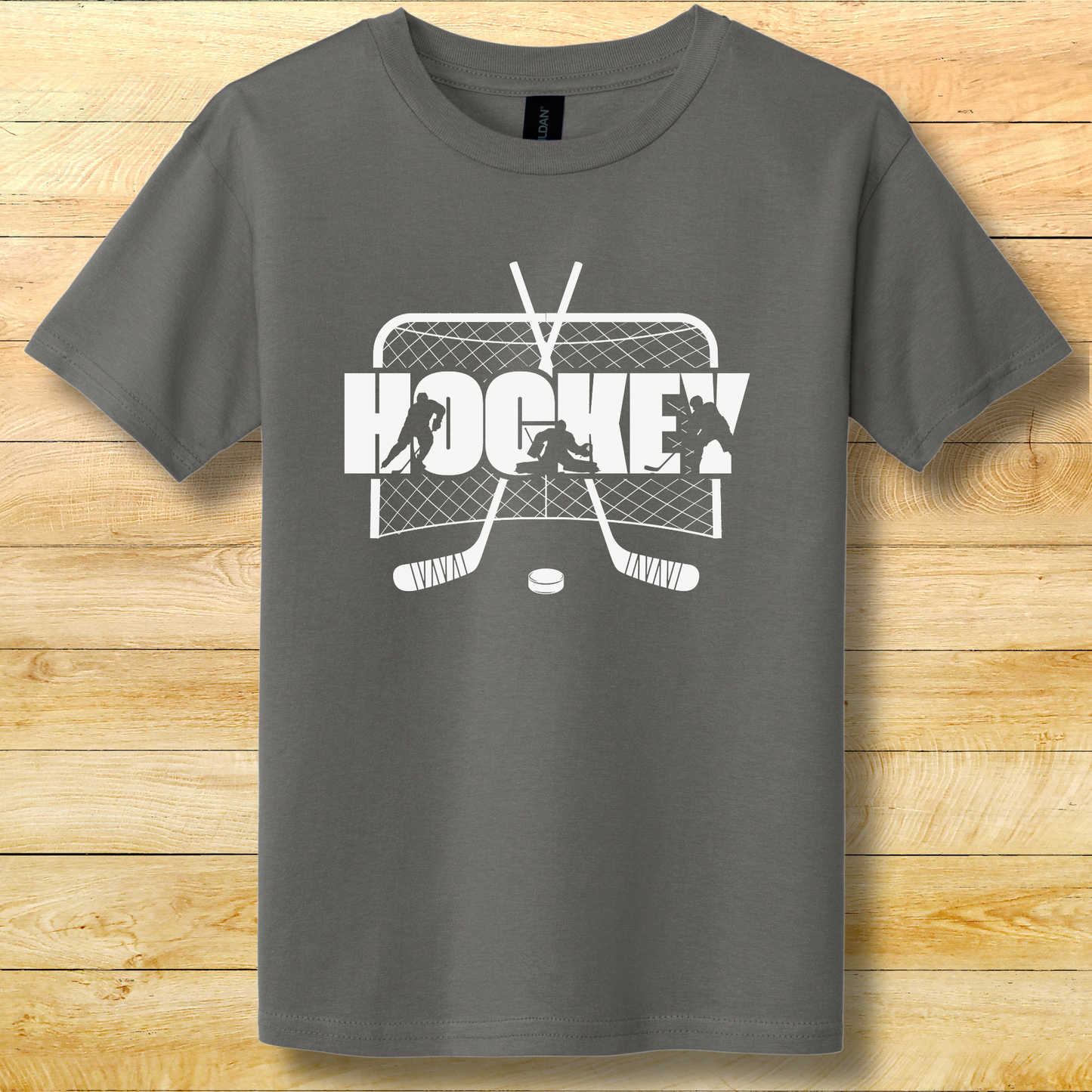 Gray t-shirt with hockey graphic design on a wooden surface