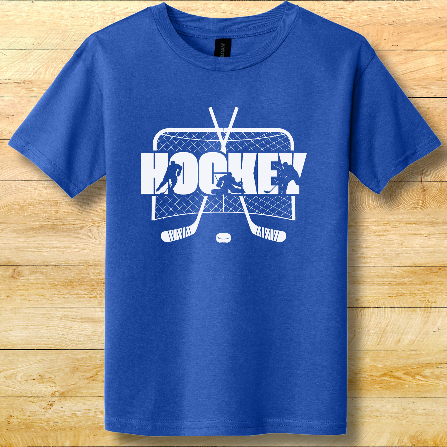 Blue t-shirt with white hockey graphic on a wooden surface