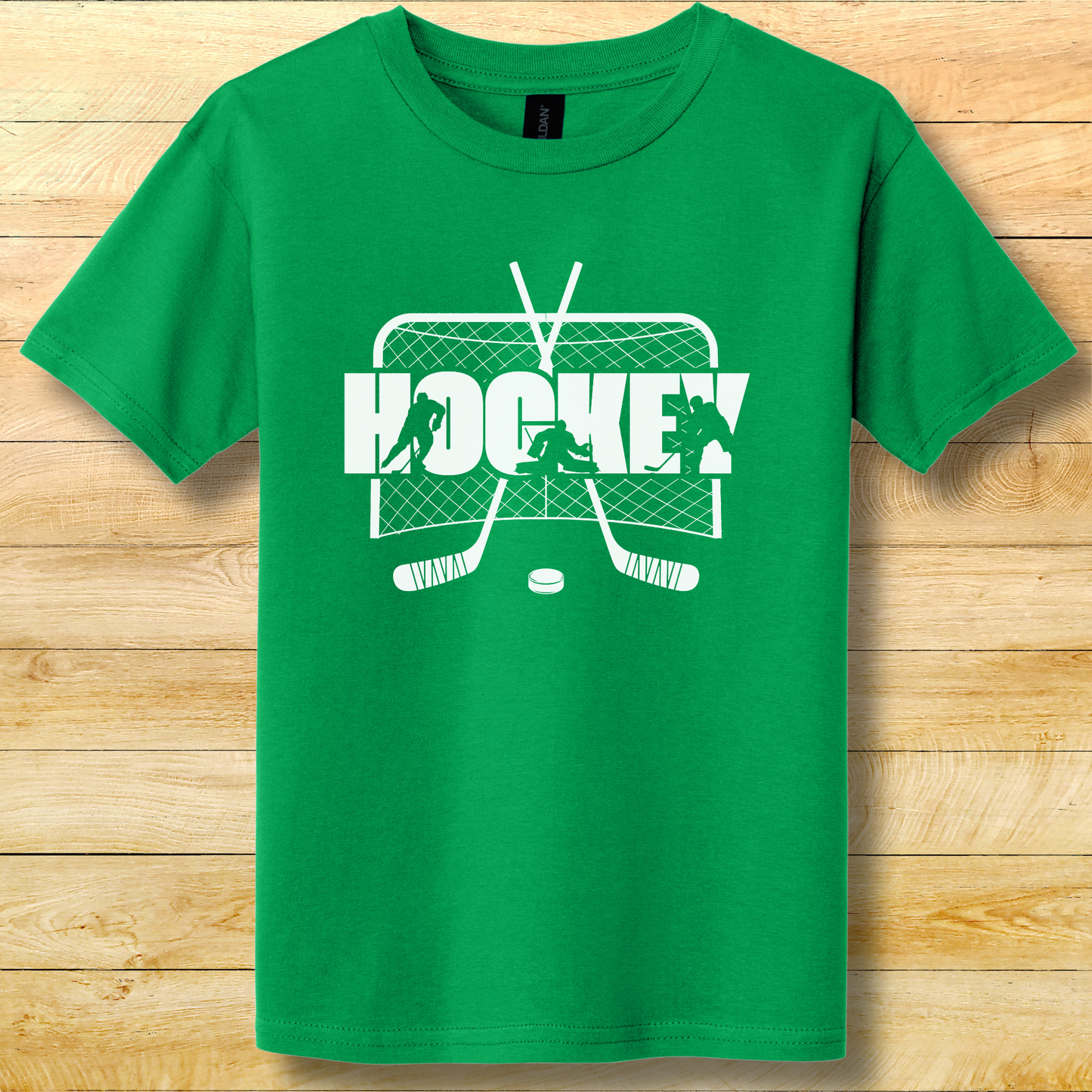 Green t-shirt with white hockey graphic on a wooden surface