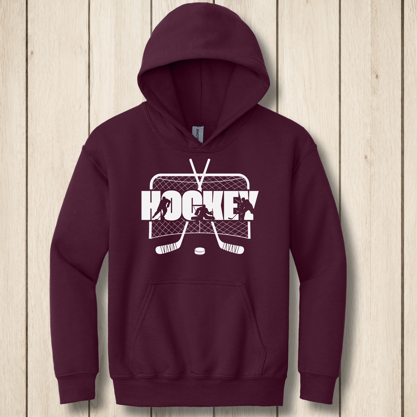Maroon hoodie with hockey graphic on a wooden surface