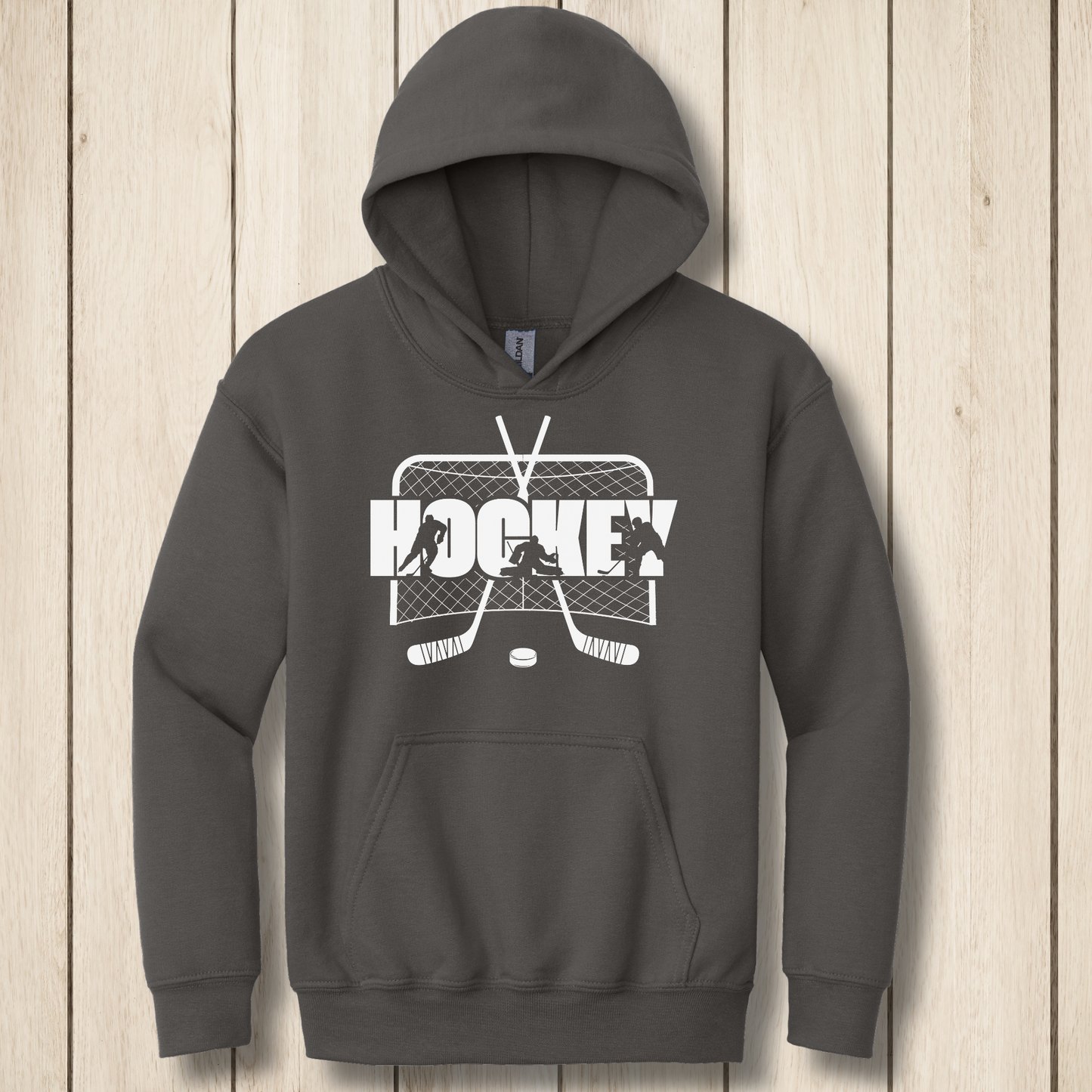 Dark gray hoodie with hockey graphic on a wooden surface