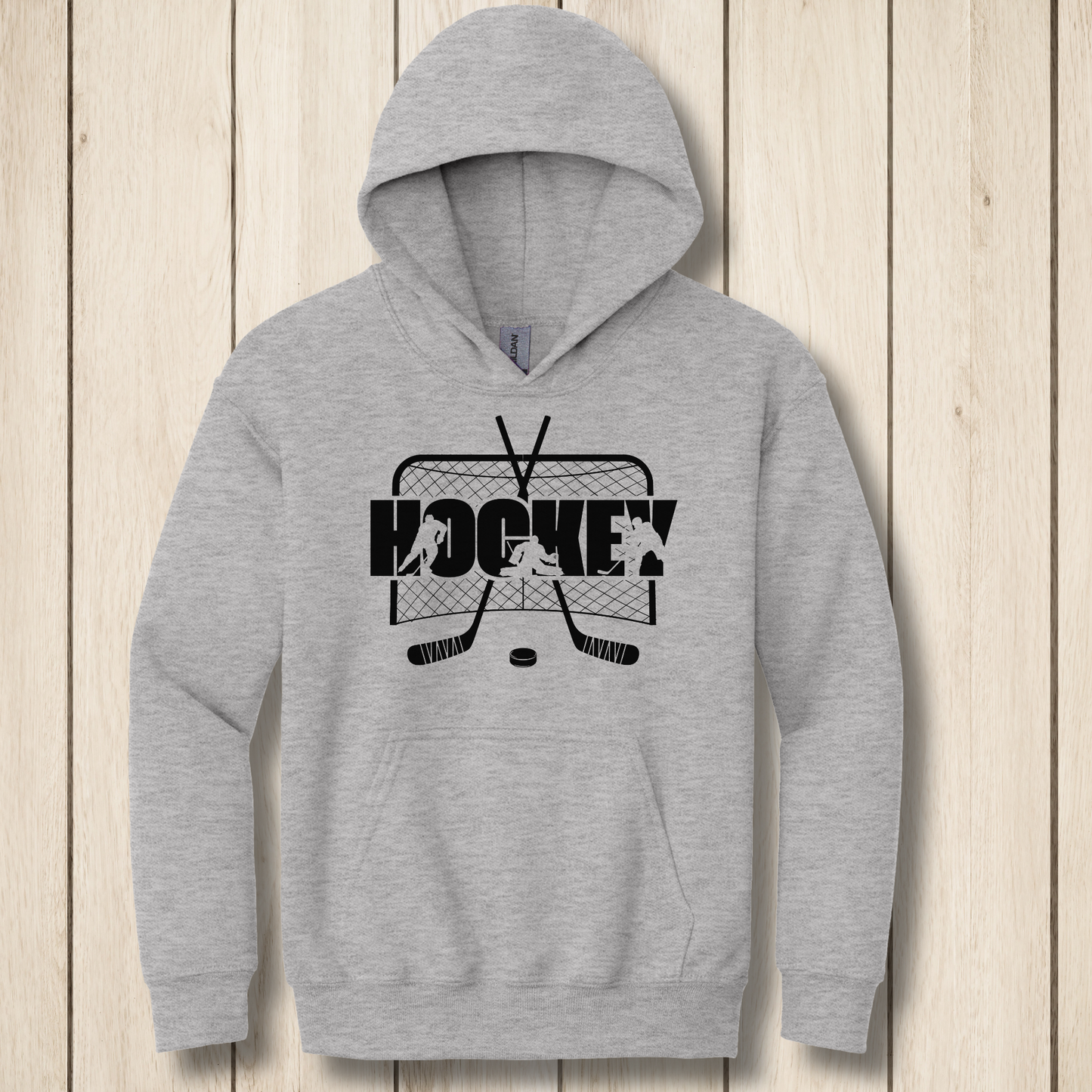 Gray hoodie with hockey graphic on a wooden surface