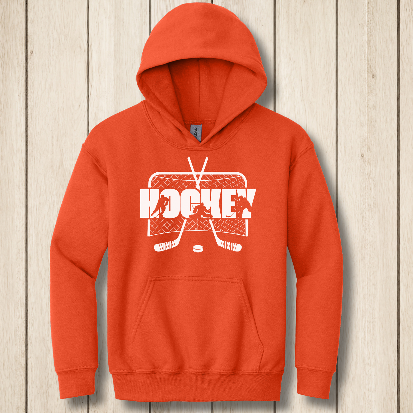 Orange hoodie with 'Hockey' graphic on a wooden surface