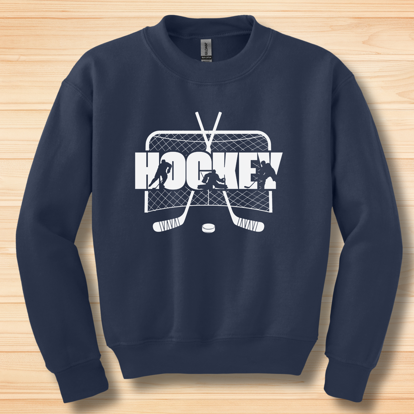 Navy blue sweatshirt with white hockey graphic on a wooden surface