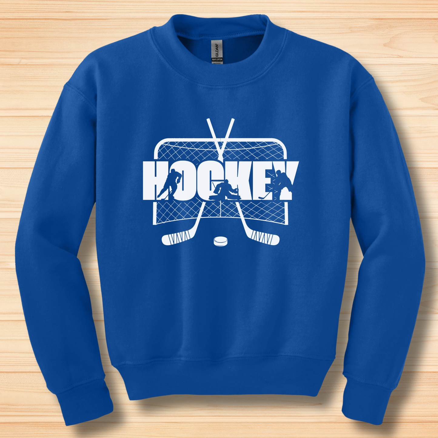 Blue sweatshirt with hockey graphic on a wooden surface
