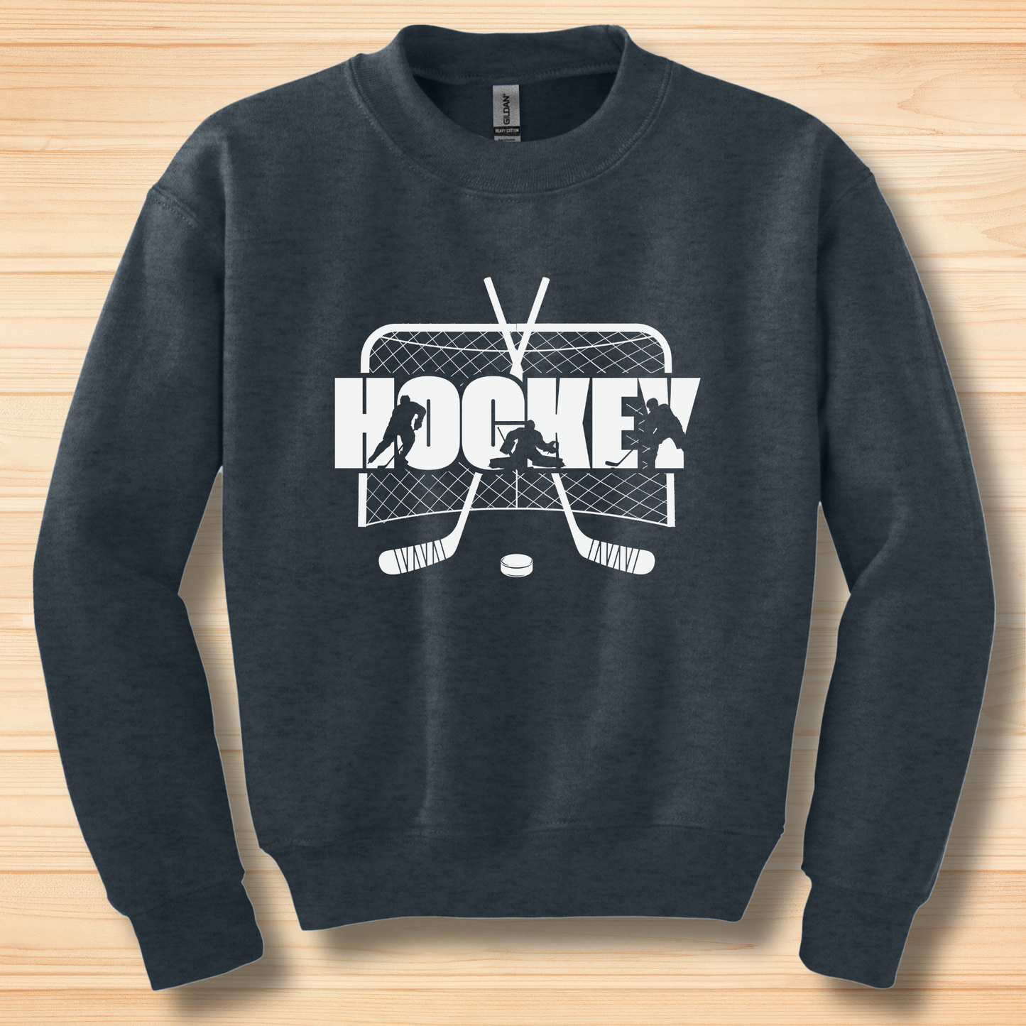 Navy blue sweatshirt with hockey graphic on a wooden surface