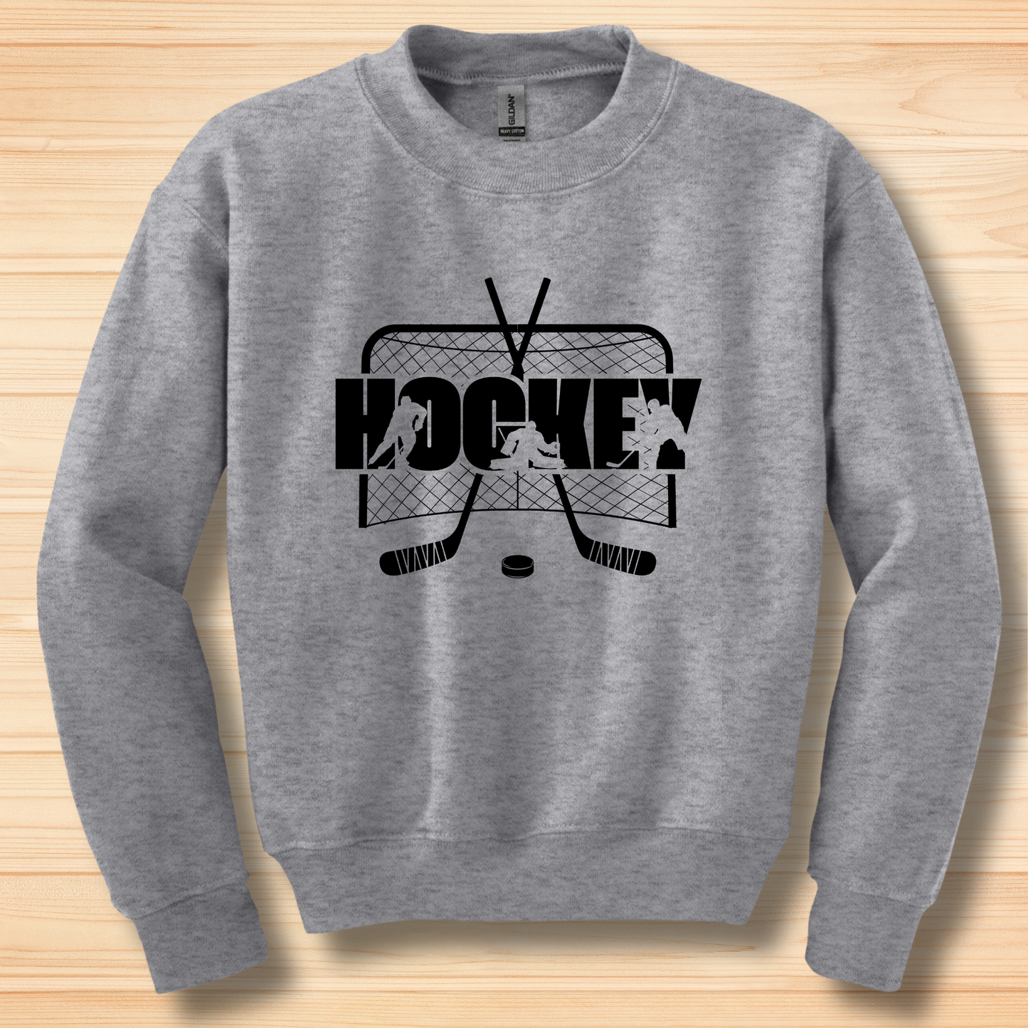 Gray sweatshirt with hockey graphic on a wooden surface