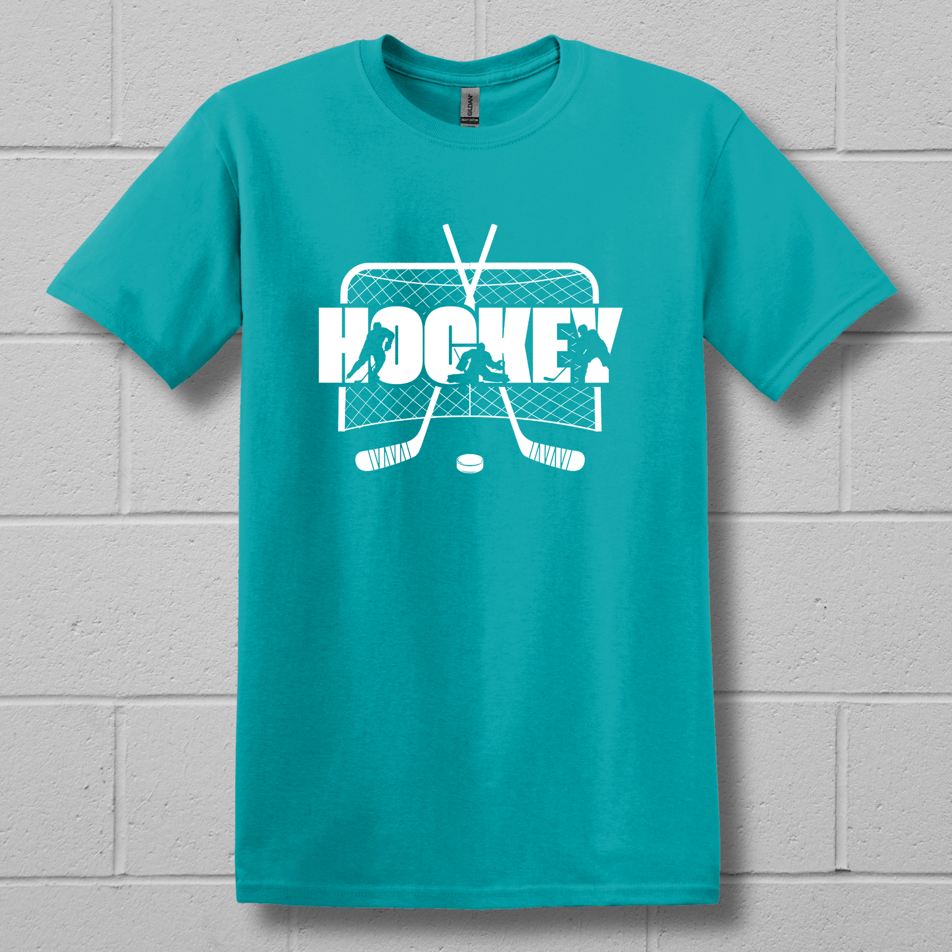 Turquoise t-shirt with white hockey graphic and text on a gray brick wall background