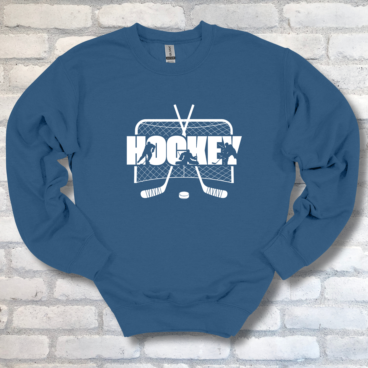 Blue sweatshirt with white hockey graphic and text on a brick wall background