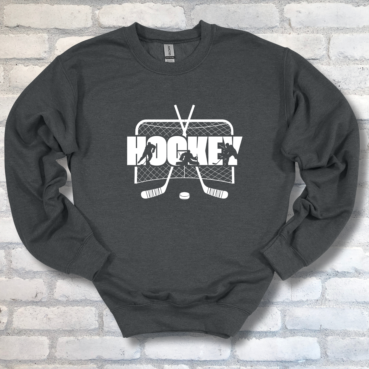 Dark gray sweatshirt with hockey graphic on a brick wall background
