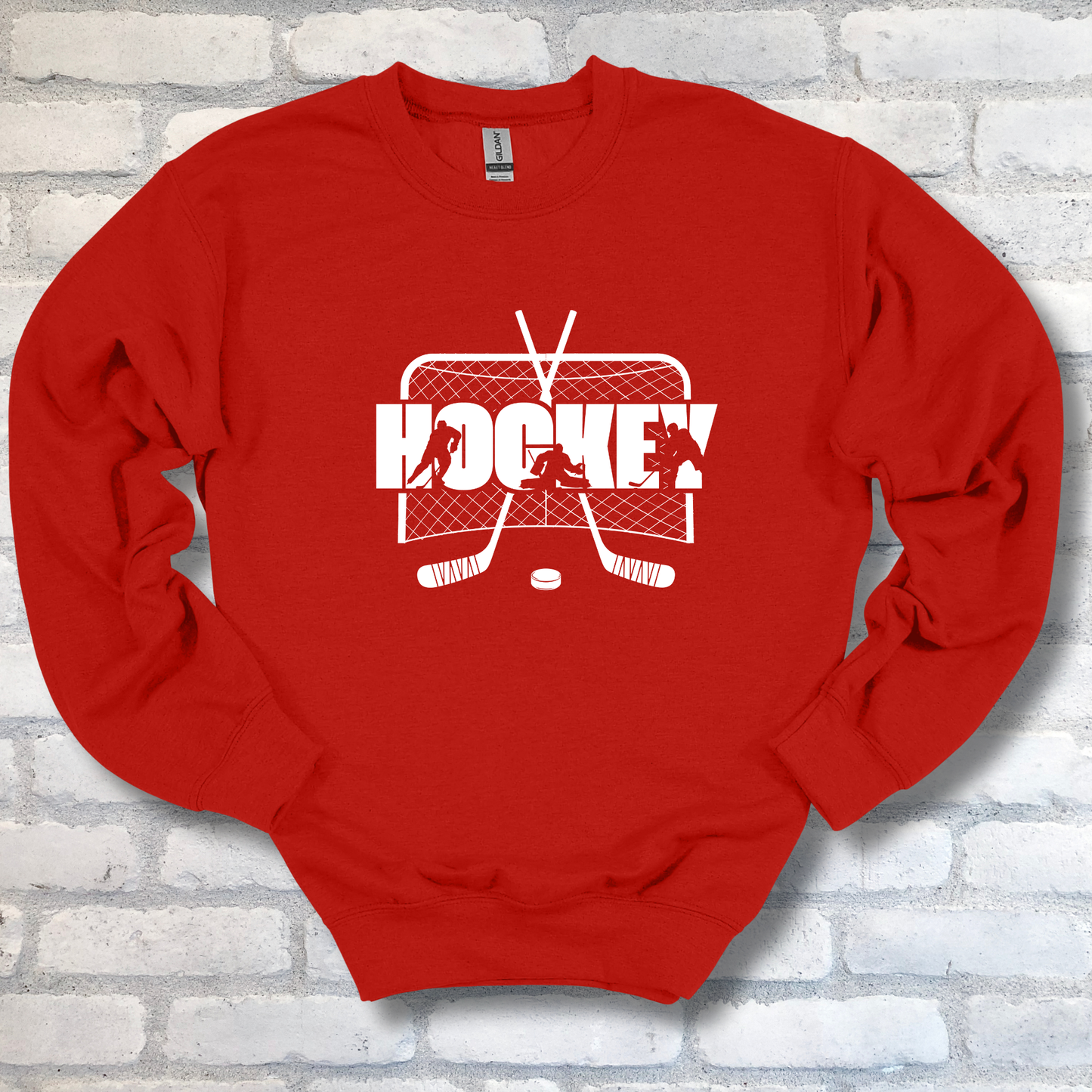 Red sweatshirt with white hockey graphic on a brick wall background