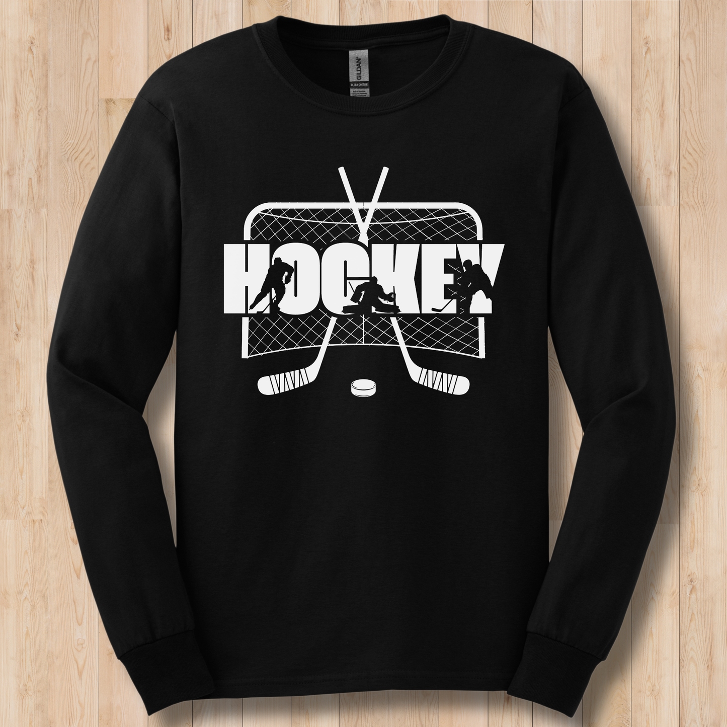 Black long-sleeve shirt with white hockey graphic on a wooden surface