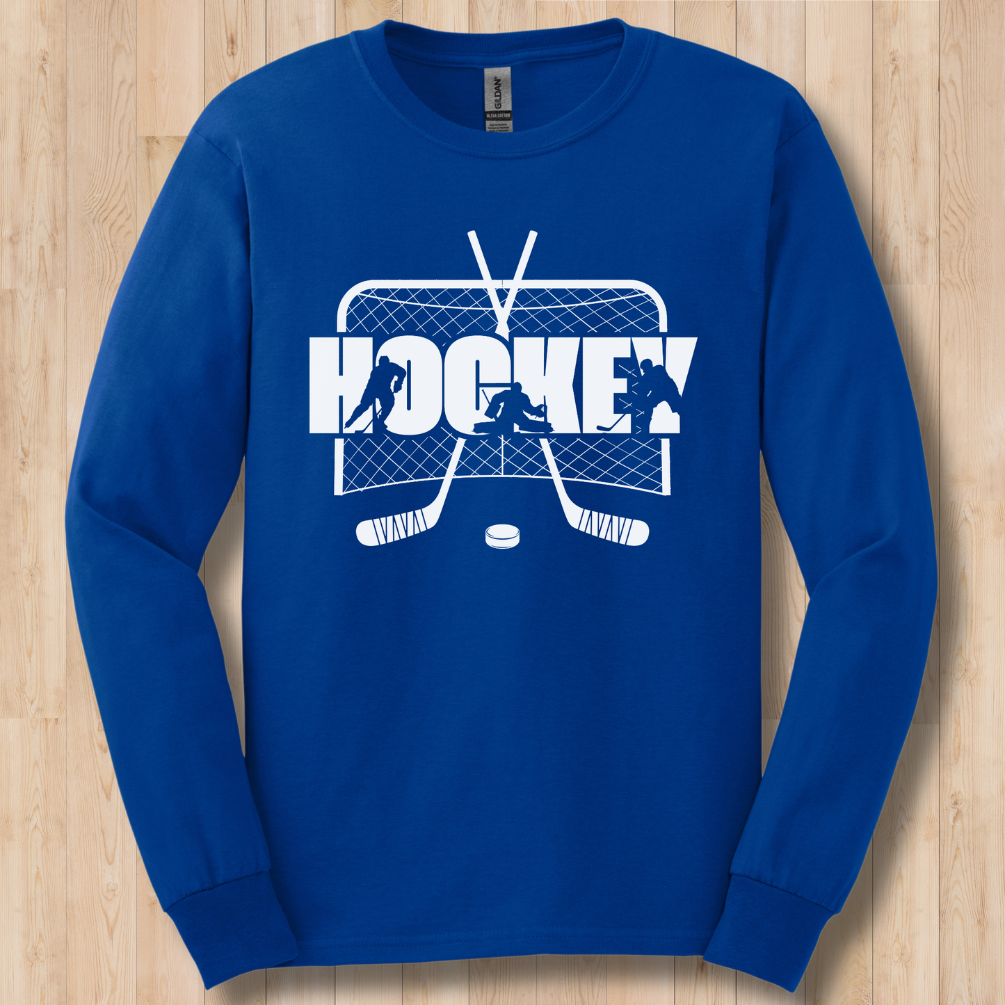 Blue long-sleeve shirt with white hockey graphic on a wooden surface