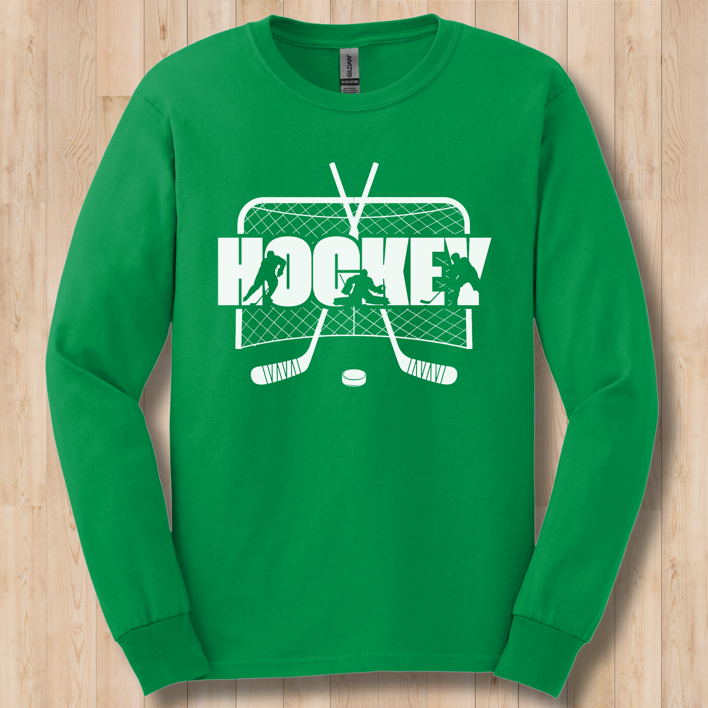 Green long-sleeve shirt with white hockey graphic on a wooden surface