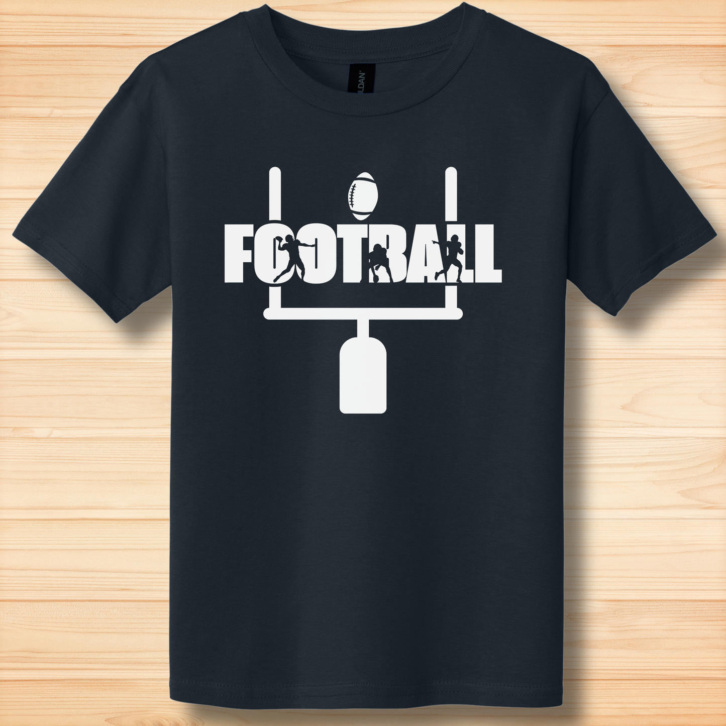 Black t-shirt with white football graphic and text on a wooden surface