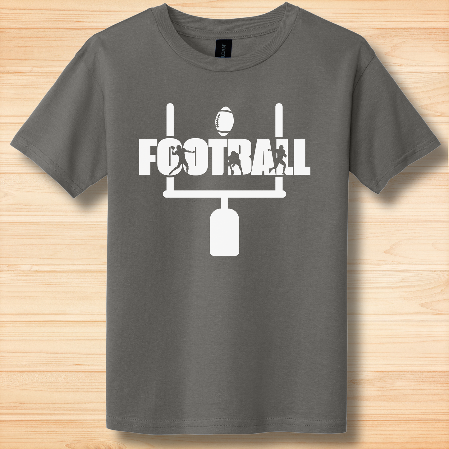 Gray t-shirt with white 'FOOTBALL' graphic on a wooden surface