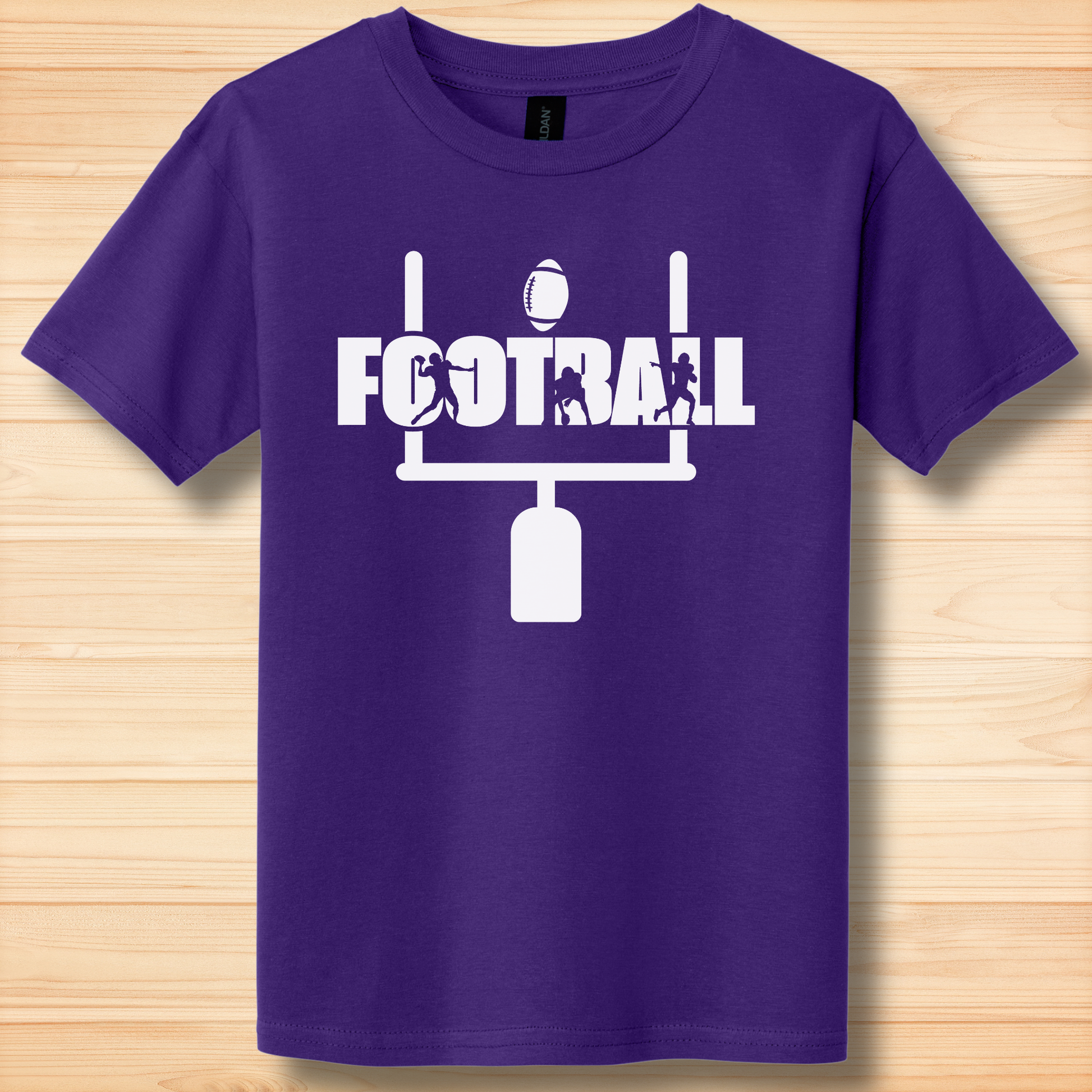 Purple t-shirt with white football graphic and text on a wooden surface