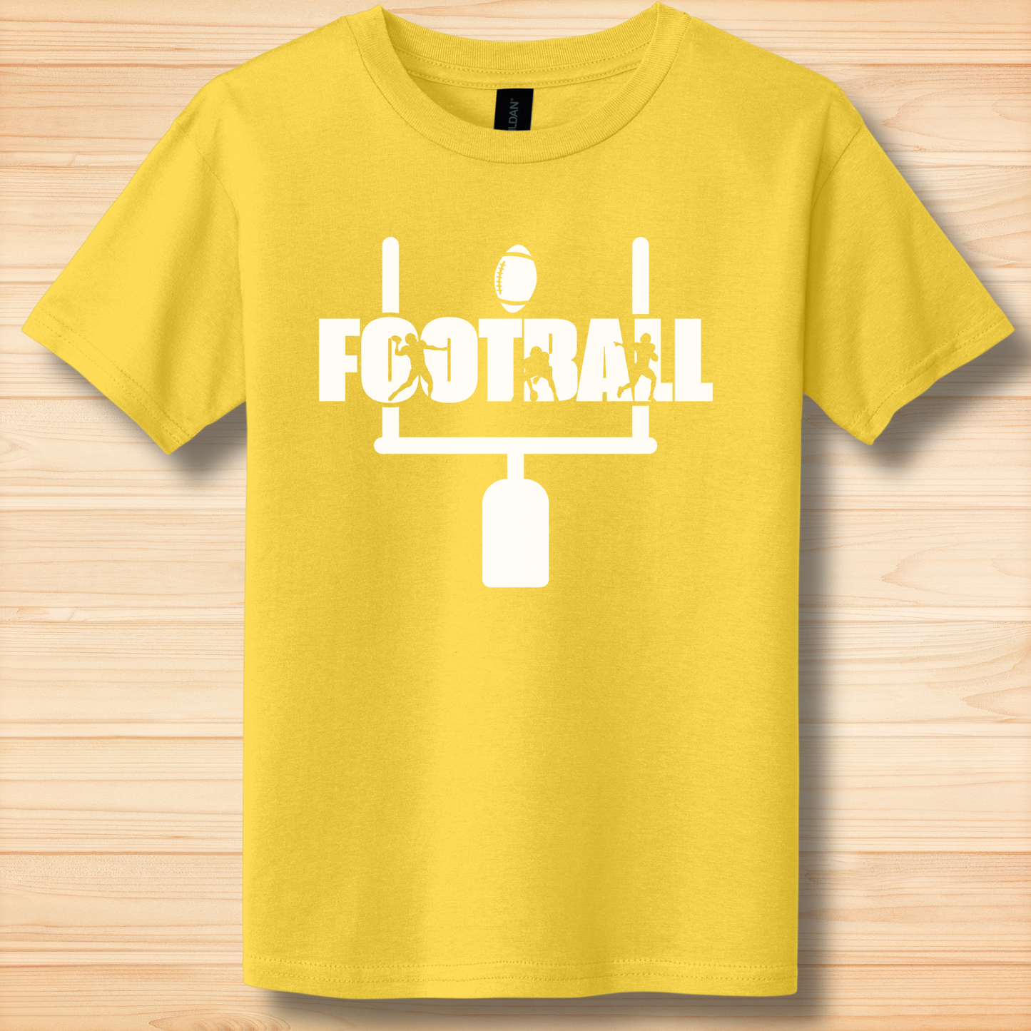 Yellow t-shirt with 'FOOTBALL' and goalpost design on a wooden surface
