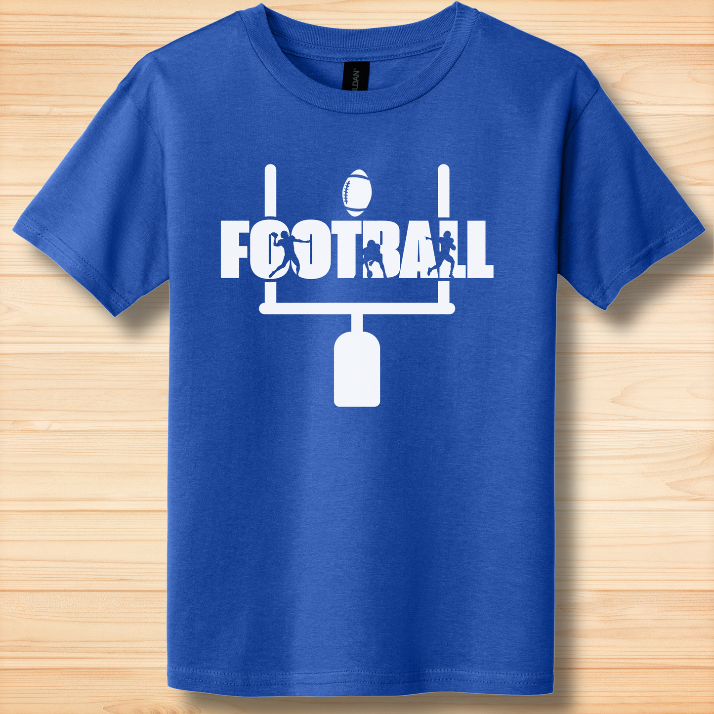 Blue t-shirt with white football graphic and text on a wooden surface
