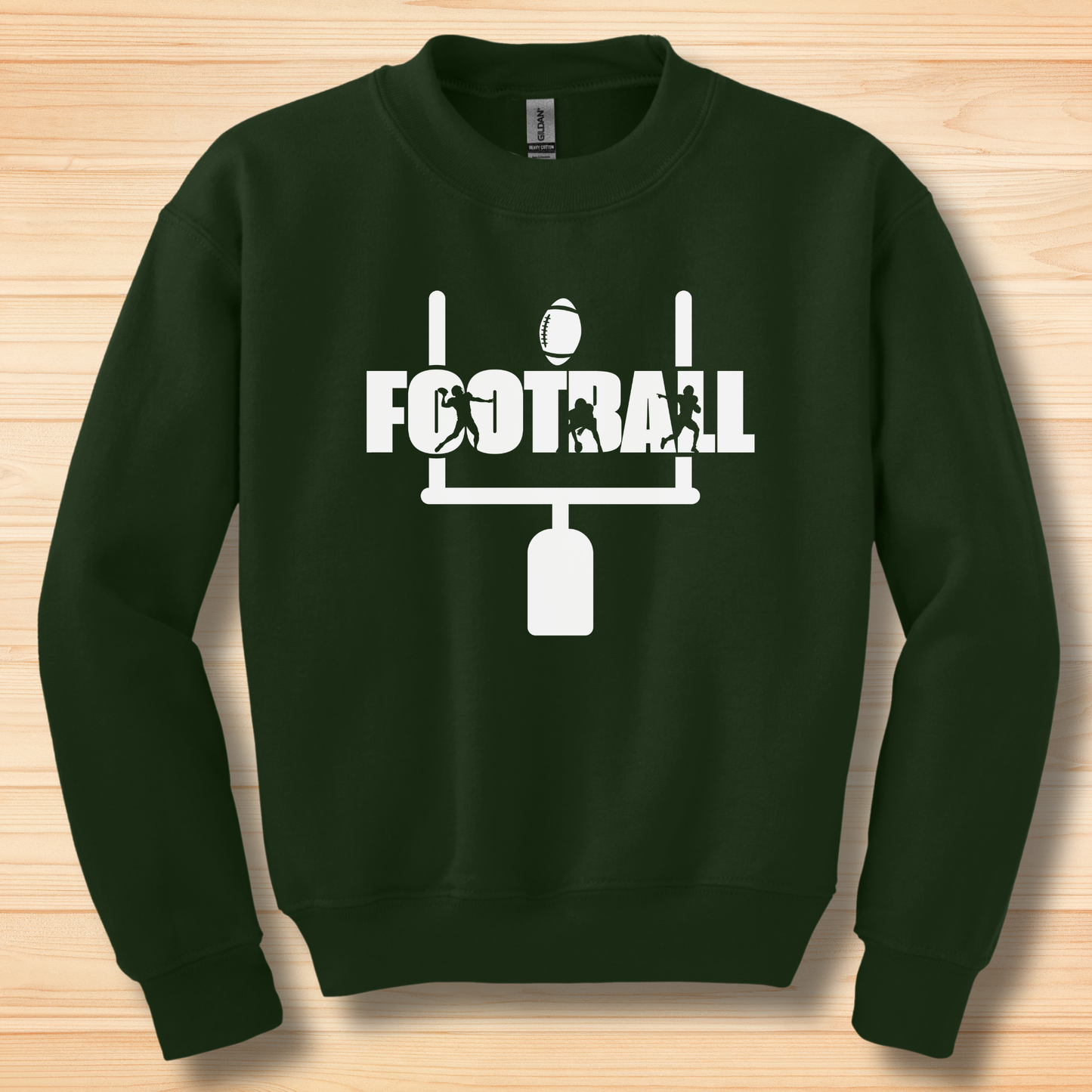 Green sweatshirt with white 'FOOTBALL' graphic on a wooden surface