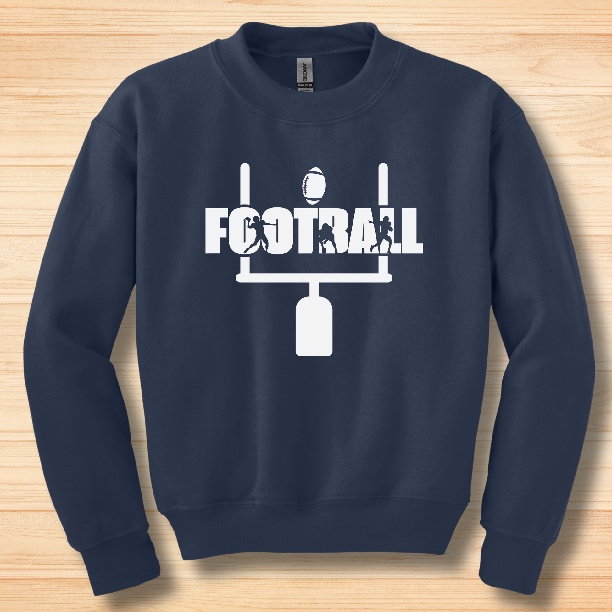 Navy blue sweatshirt with white football graphic on a wooden surface
